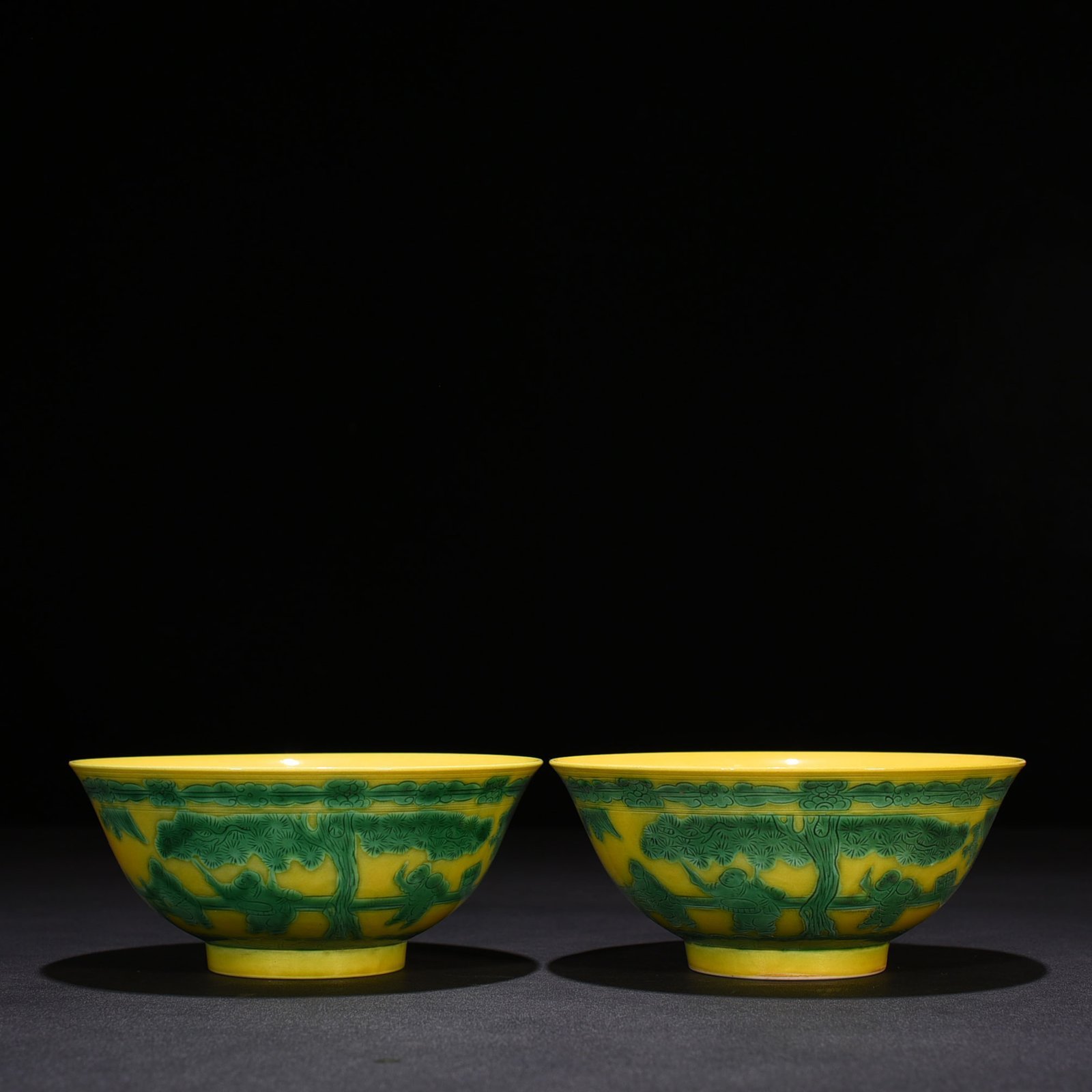 Qing Dynasty Kangxi yellow glaze engraved green color baby playing bowl