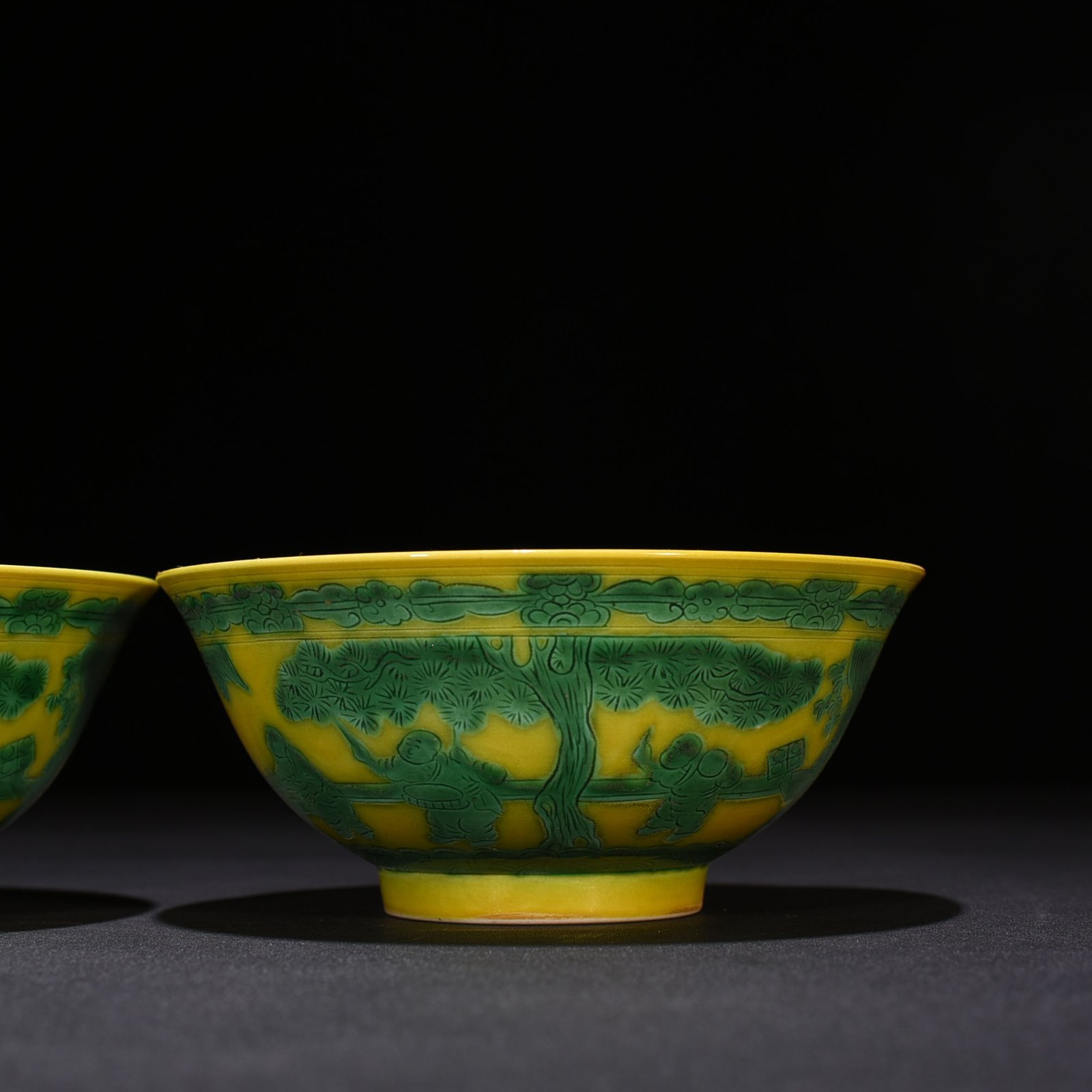 Qing Dynasty Kangxi yellow glaze engraved green color baby playing bowl