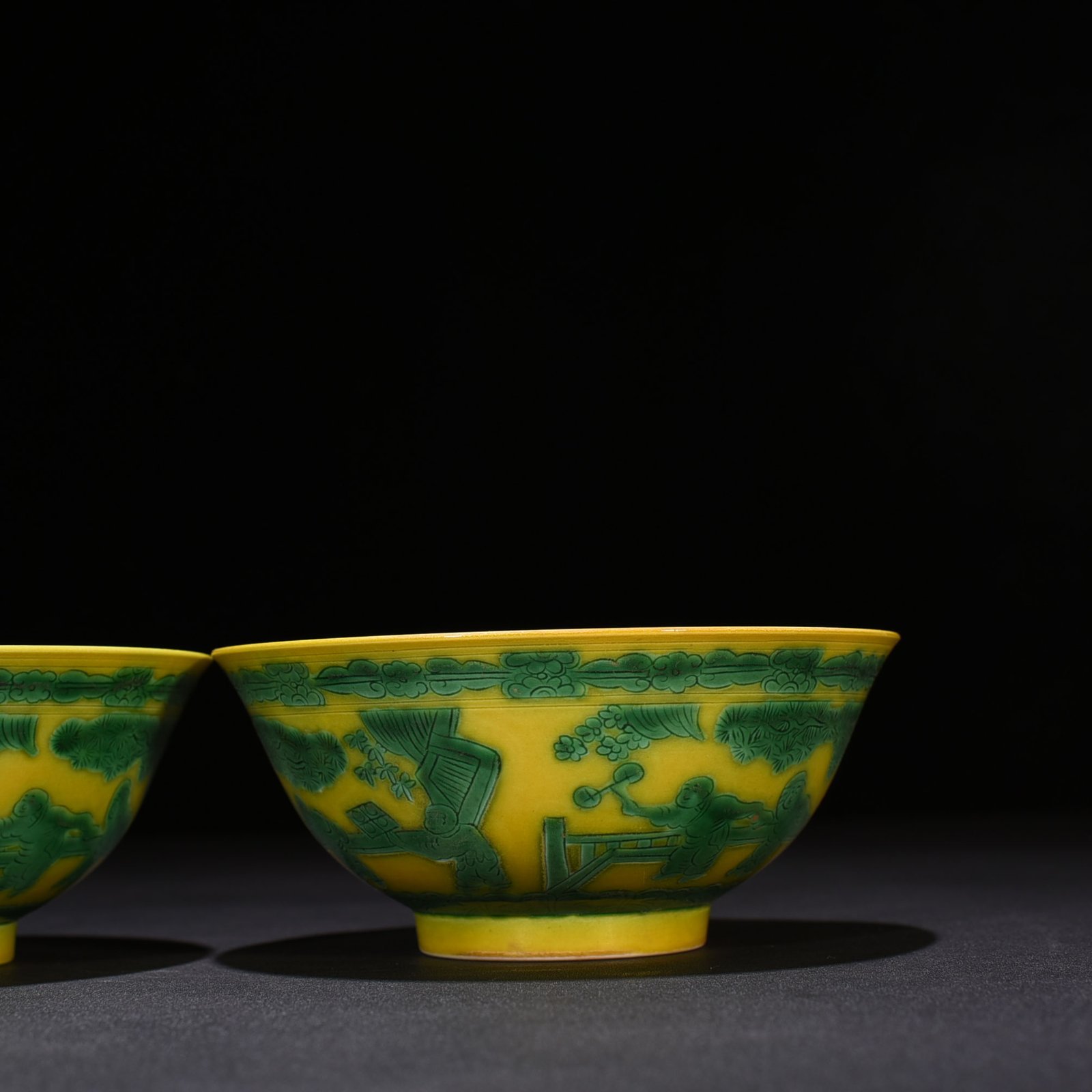 Qing Dynasty Kangxi yellow glaze engraved green color baby playing bowl