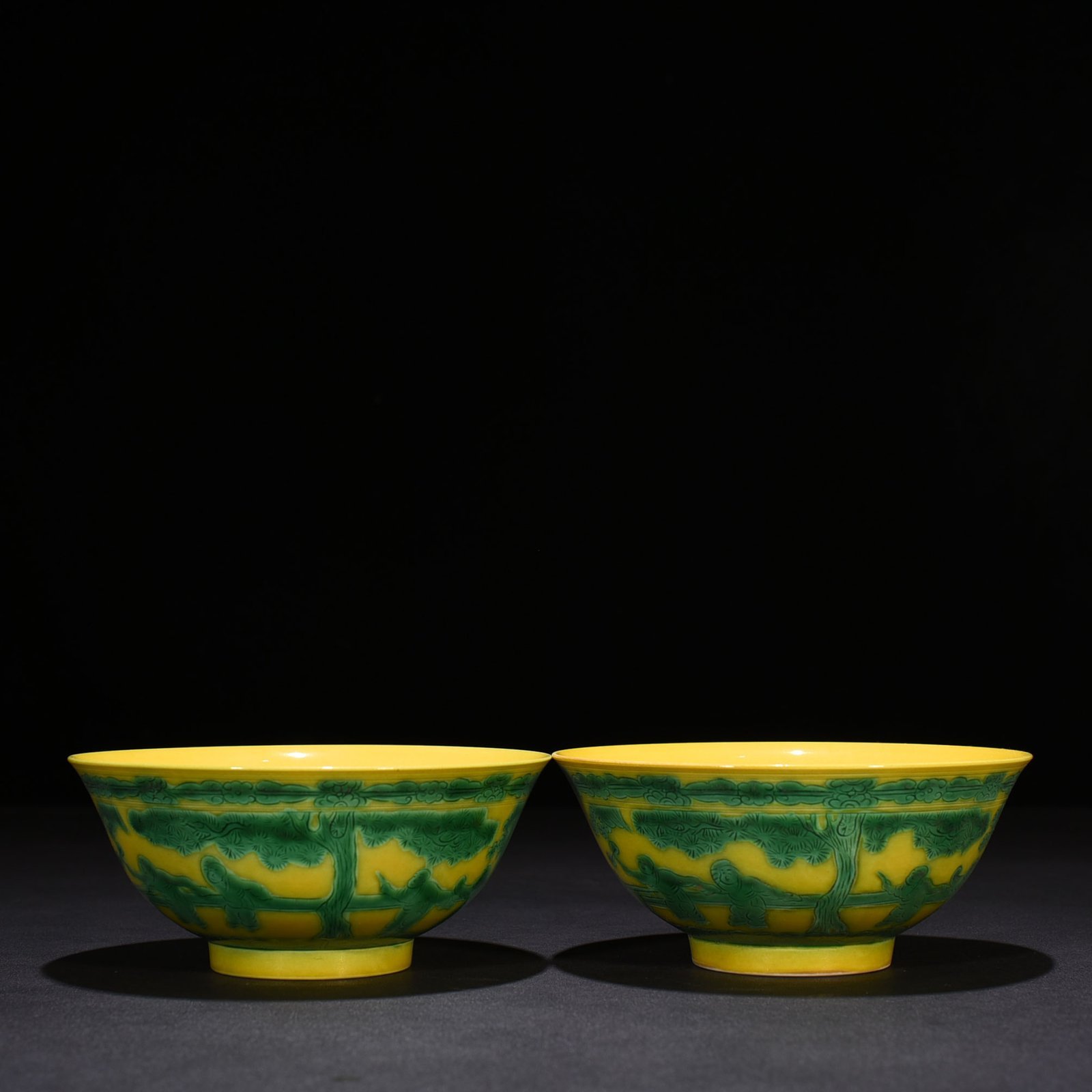 Qing Dynasty Kangxi yellow glaze engraved green color baby playing bowl