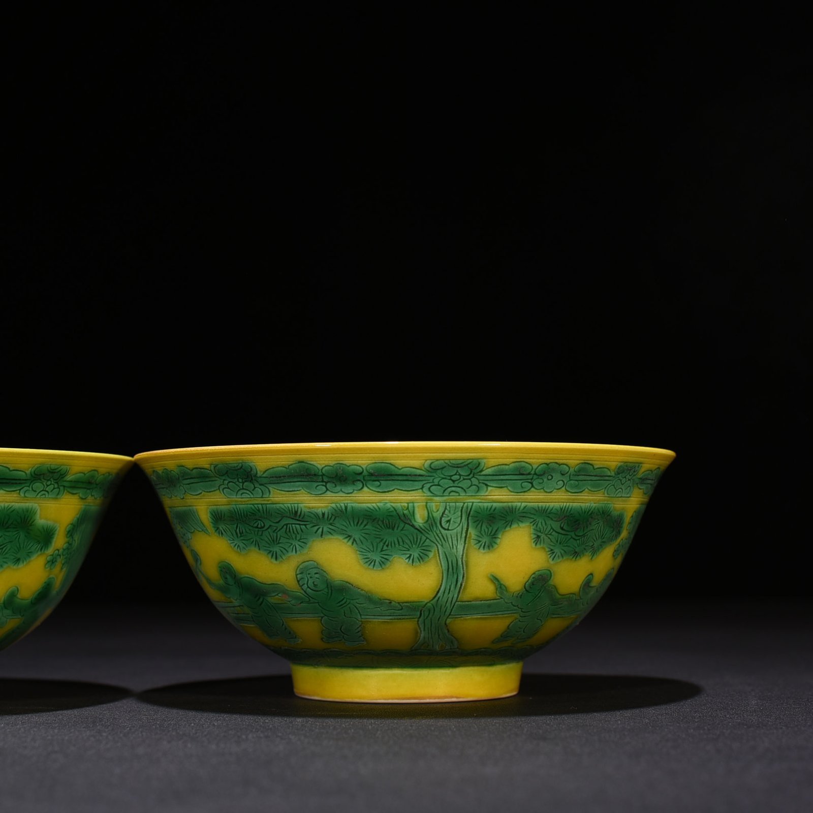 Qing Dynasty Kangxi yellow glaze engraved green color baby playing bowl