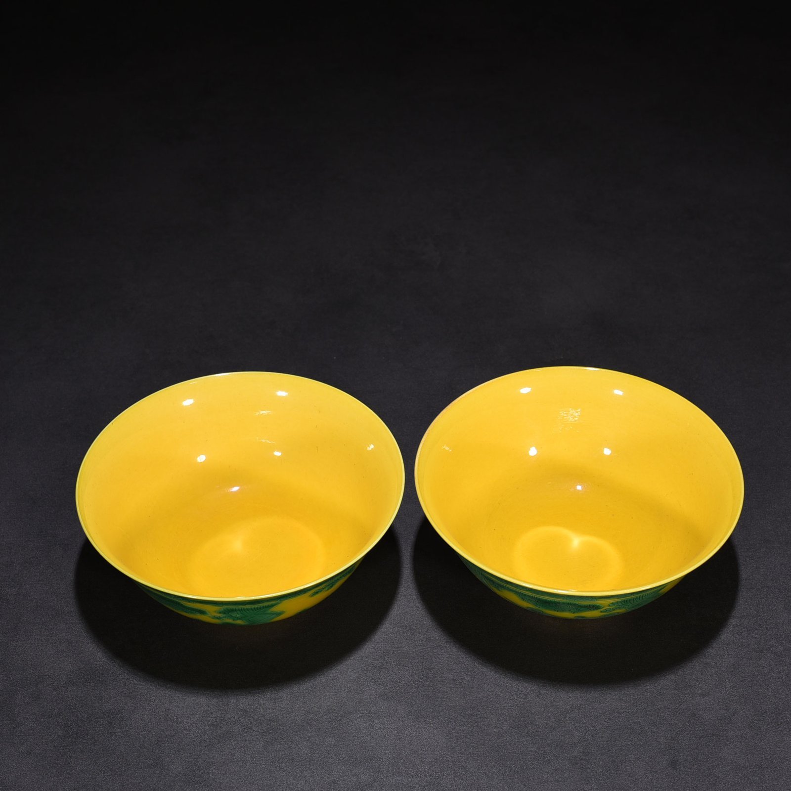 Qing Dynasty Kangxi yellow glaze engraved green color baby playing bowl