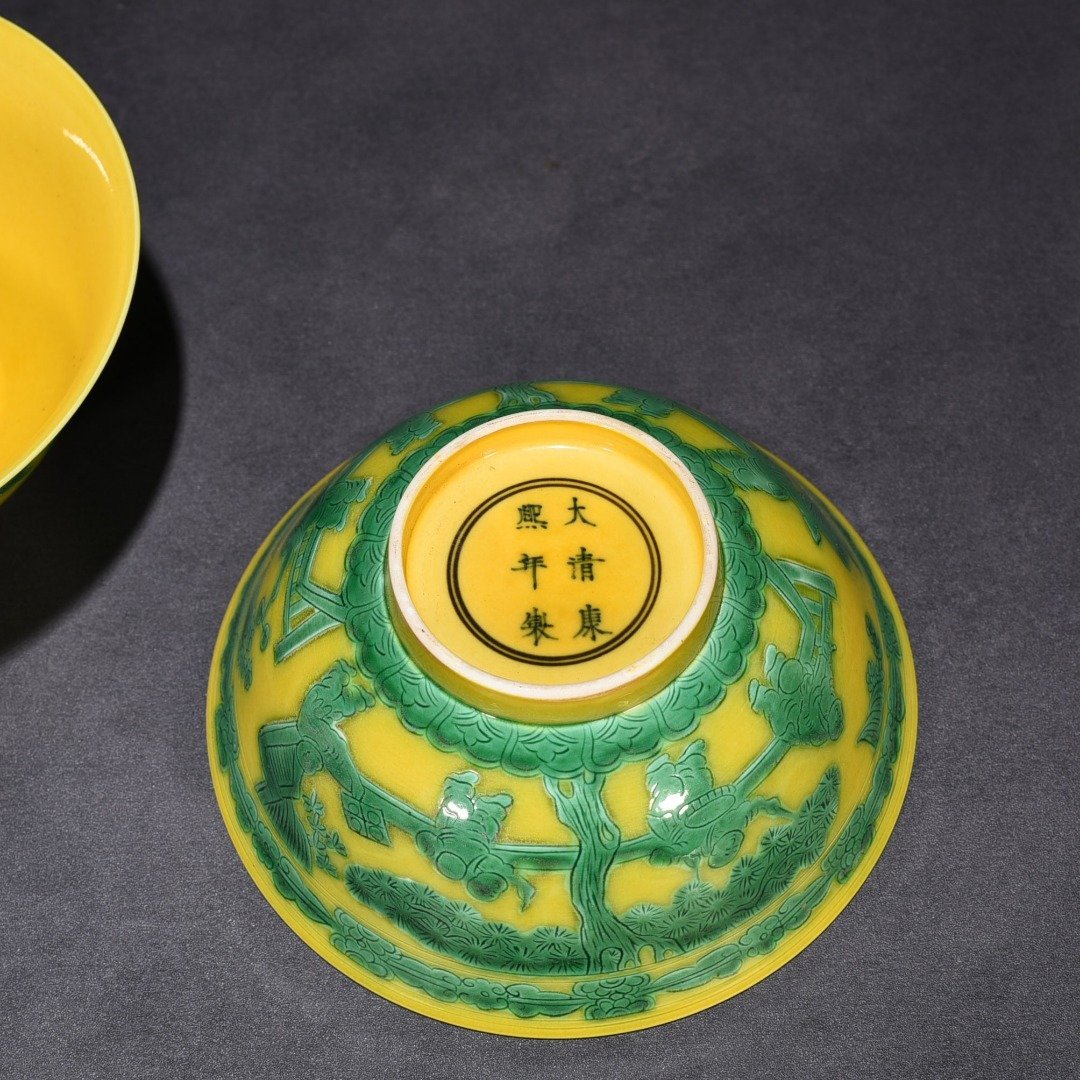 Qing Dynasty Kangxi yellow glaze engraved green color baby playing bowl