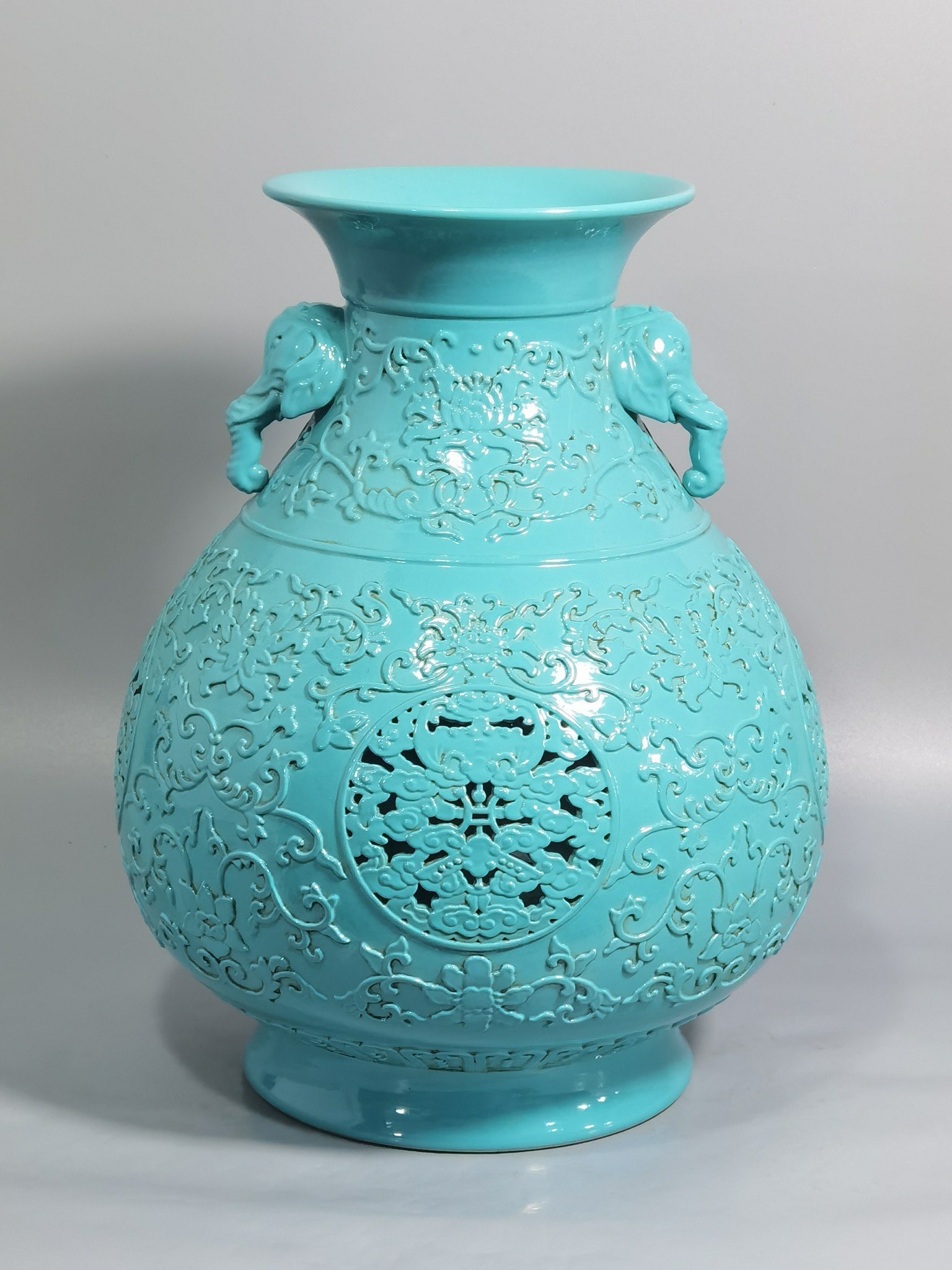 Qing Dynasty Qianlong turquoise green glaze hollow lotus and longevity pattern elephant ear vase