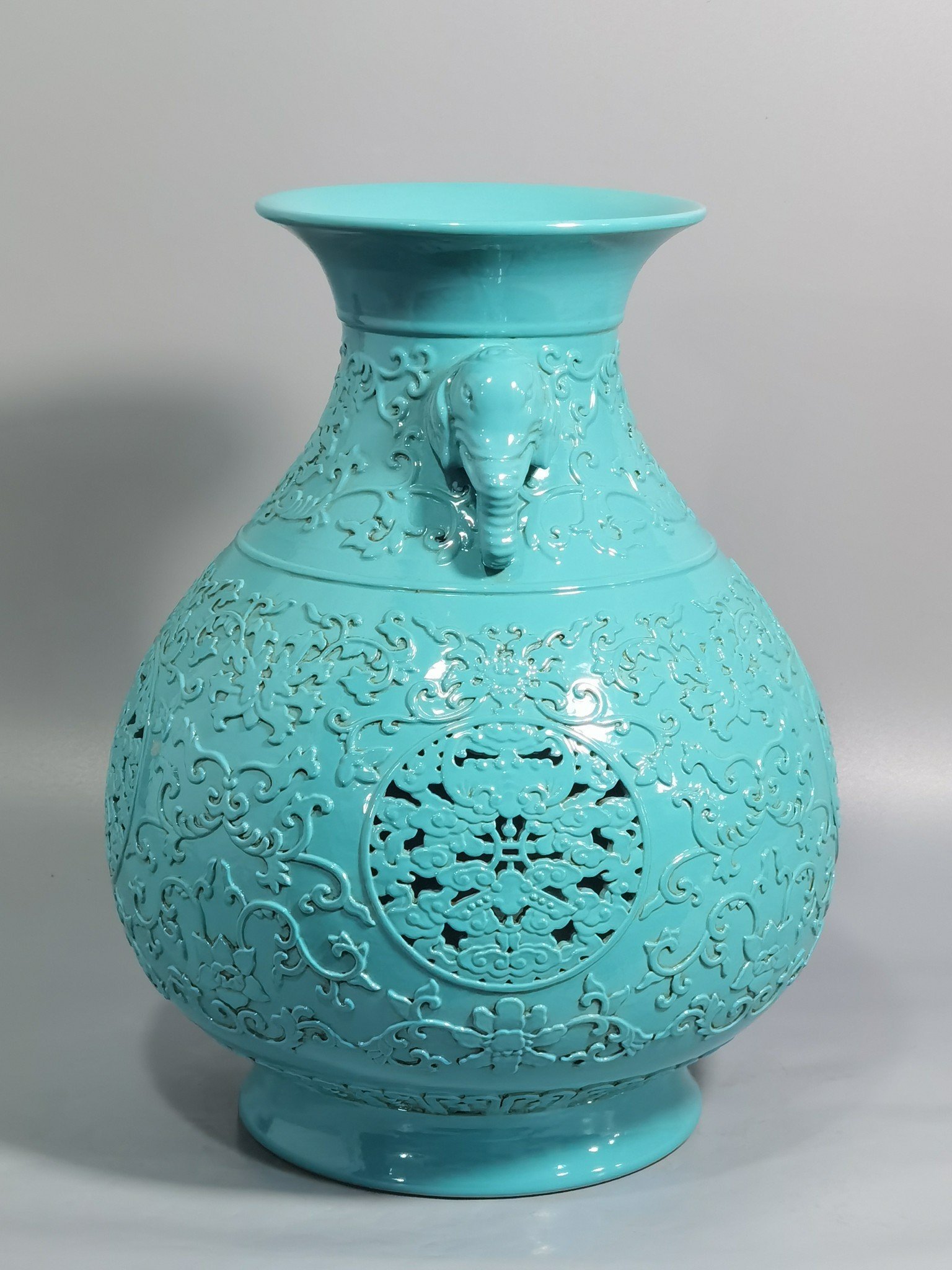 Qing Dynasty Qianlong turquoise green glaze hollow lotus and longevity pattern elephant ear vase