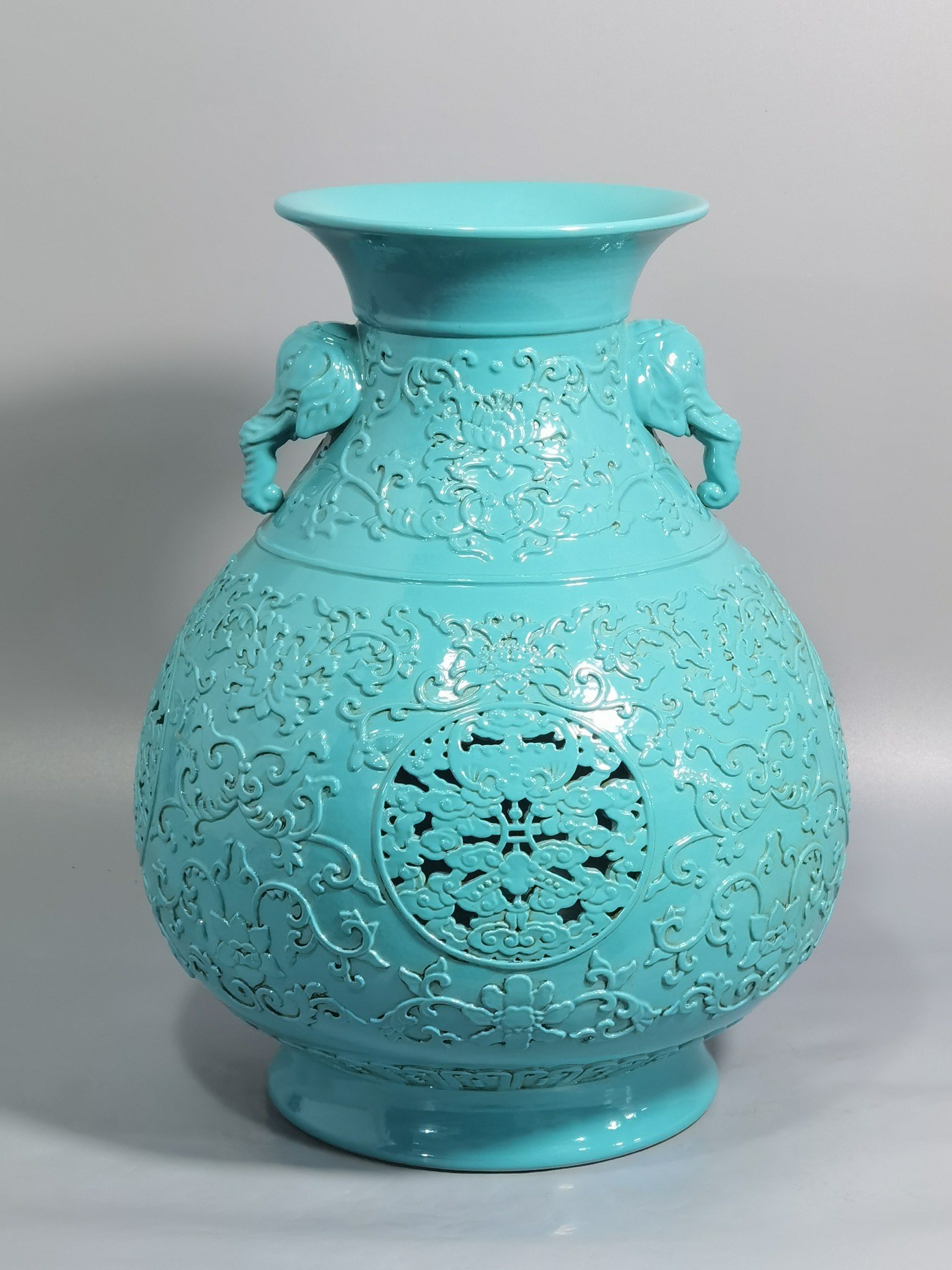 Qing Dynasty Qianlong turquoise green glaze hollow lotus and longevity pattern elephant ear vase