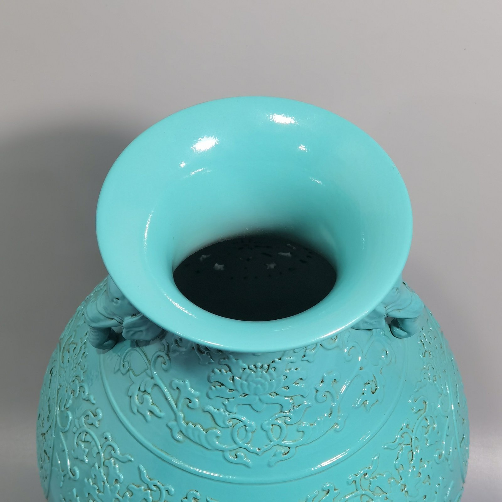 Qing Dynasty Qianlong turquoise green glaze hollow lotus and longevity pattern elephant ear vase
