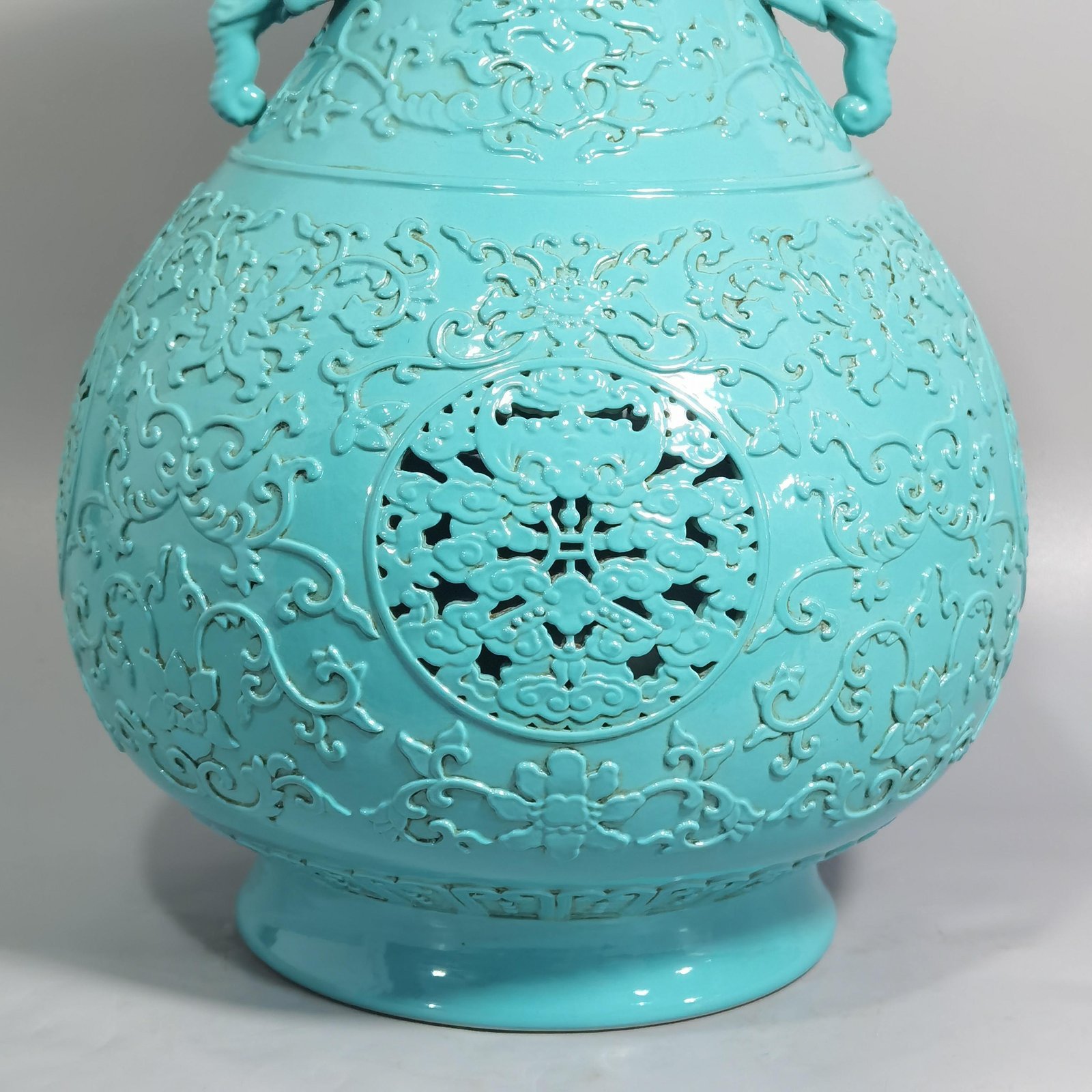 Qing Dynasty Qianlong turquoise green glaze hollow lotus and longevity pattern elephant ear vase
