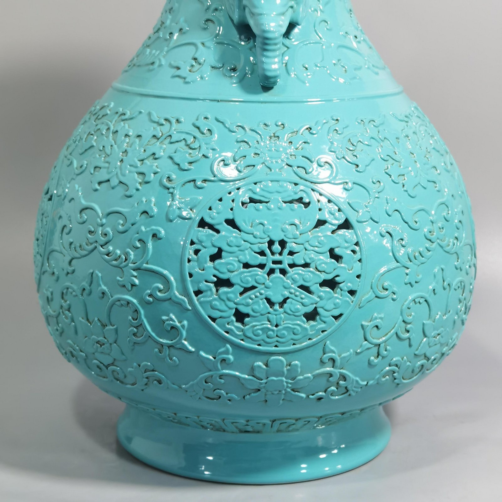 Qing Dynasty Qianlong turquoise green glaze hollow lotus and longevity pattern elephant ear vase