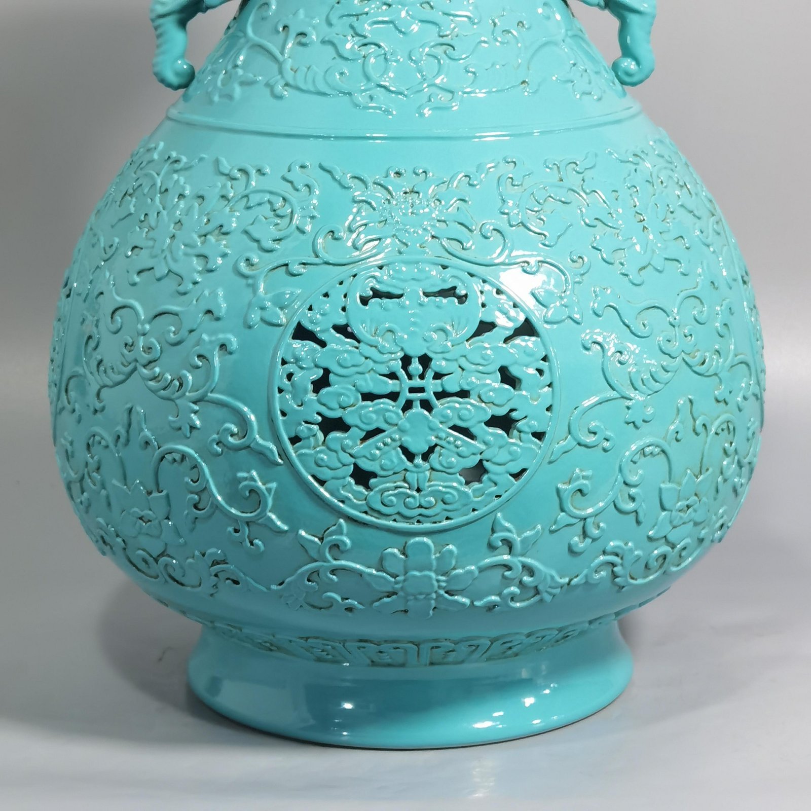 Qing Dynasty Qianlong turquoise green glaze hollow lotus and longevity pattern elephant ear vase
