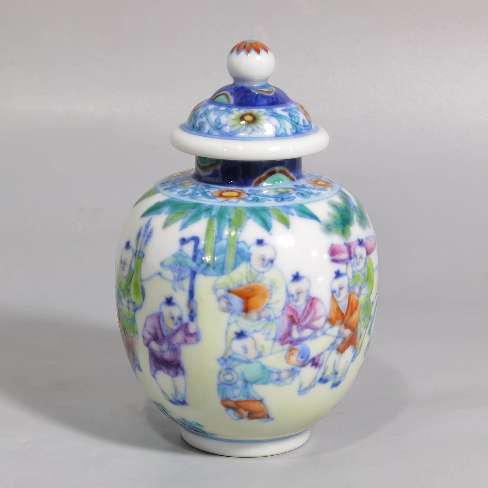 Qing Dynasty Qianlong blue and white colored baby playing picture covered jar