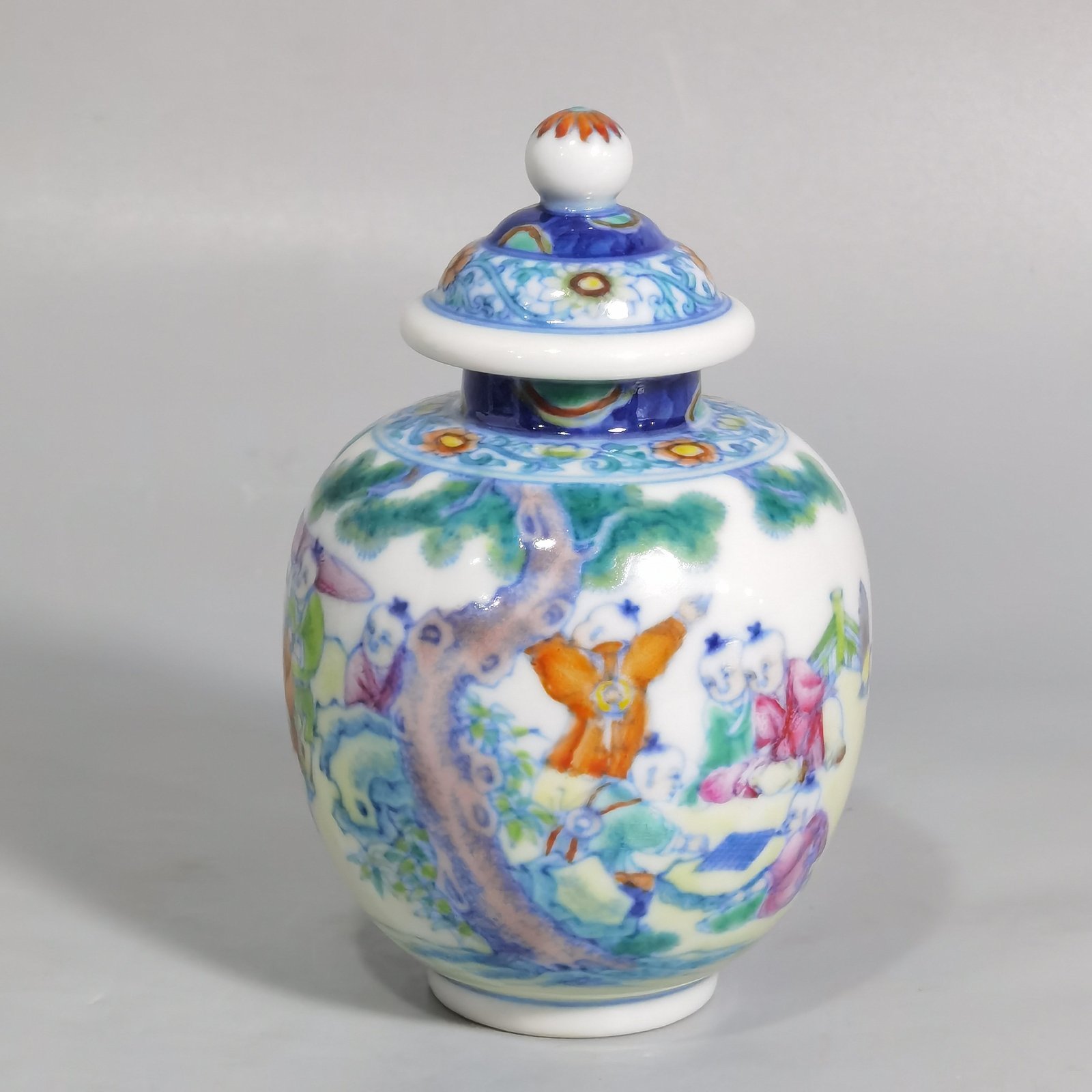 Qing Dynasty Qianlong blue and white colored baby playing picture covered jar