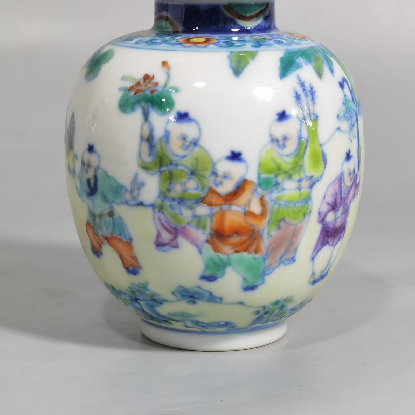 Qing Dynasty Qianlong blue and white colored baby playing picture covered jar
