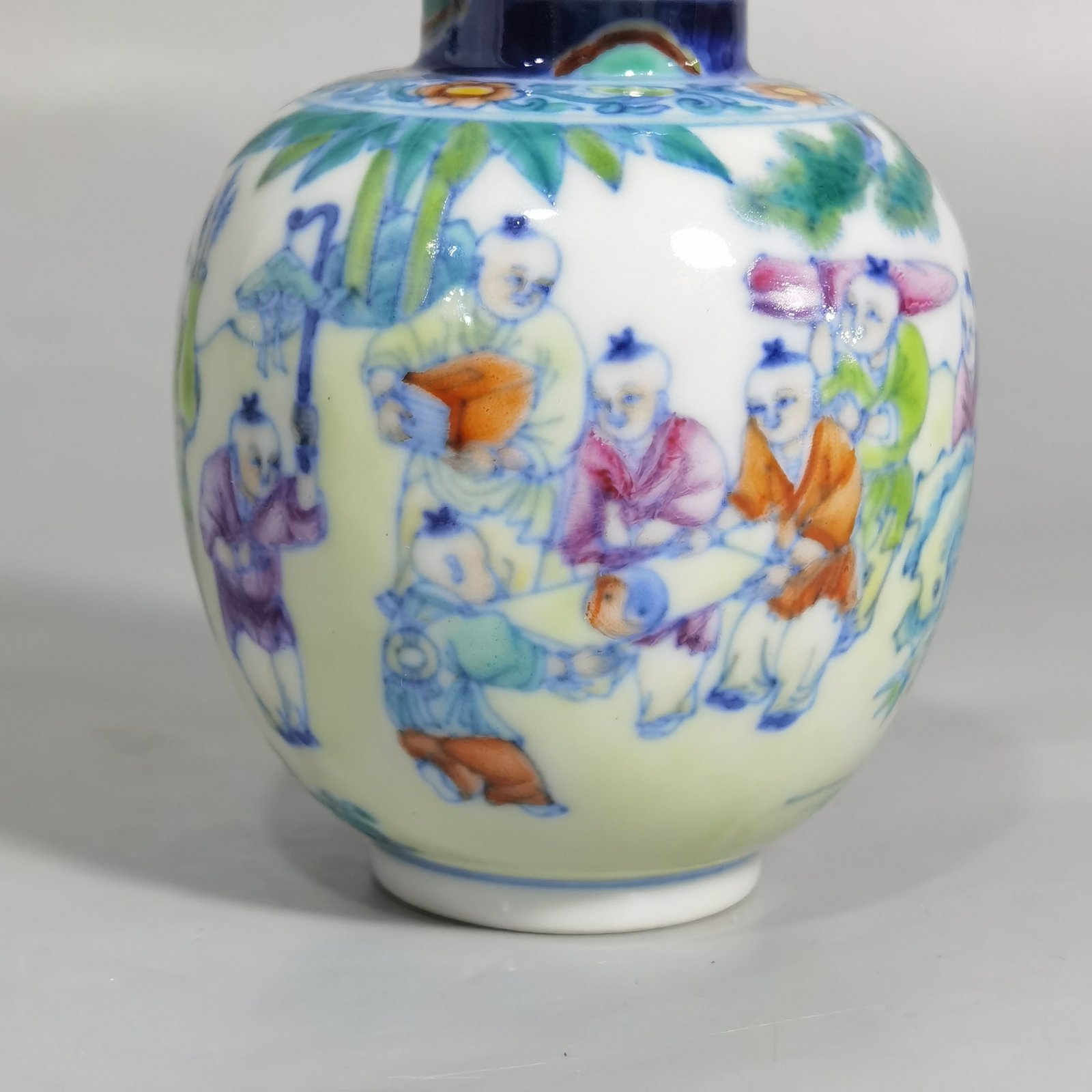 Qing Dynasty Qianlong blue and white colored baby playing picture covered jar