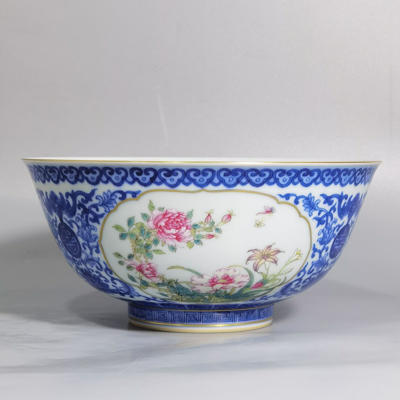 Qing Dynasty Qianlong blue and white longevity and longevity branches windowed pastel flower pattern bowl
