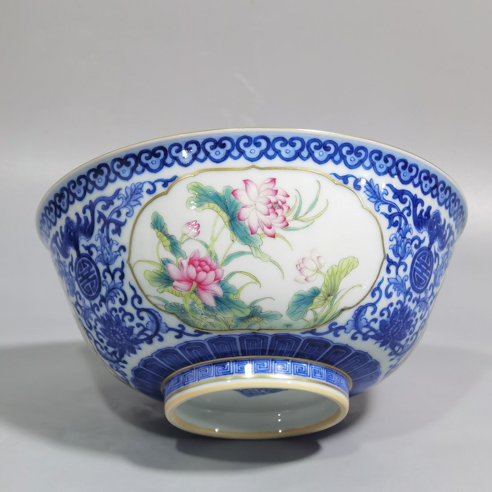 Qing Dynasty Qianlong blue and white longevity and longevity branches windowed pastel flower pattern bowl