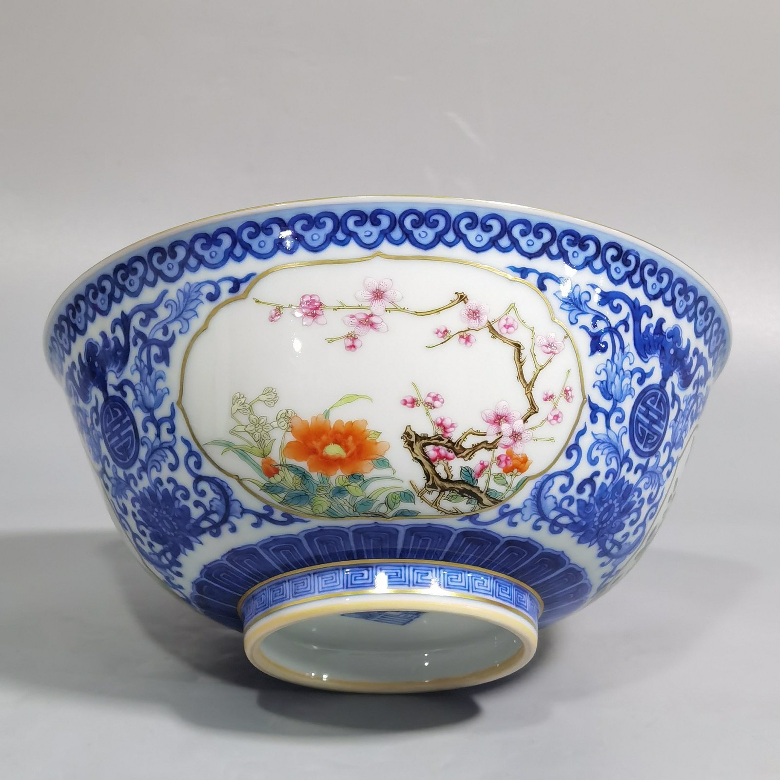 Qing Dynasty Qianlong blue and white longevity and longevity branches windowed pastel flower pattern bowl