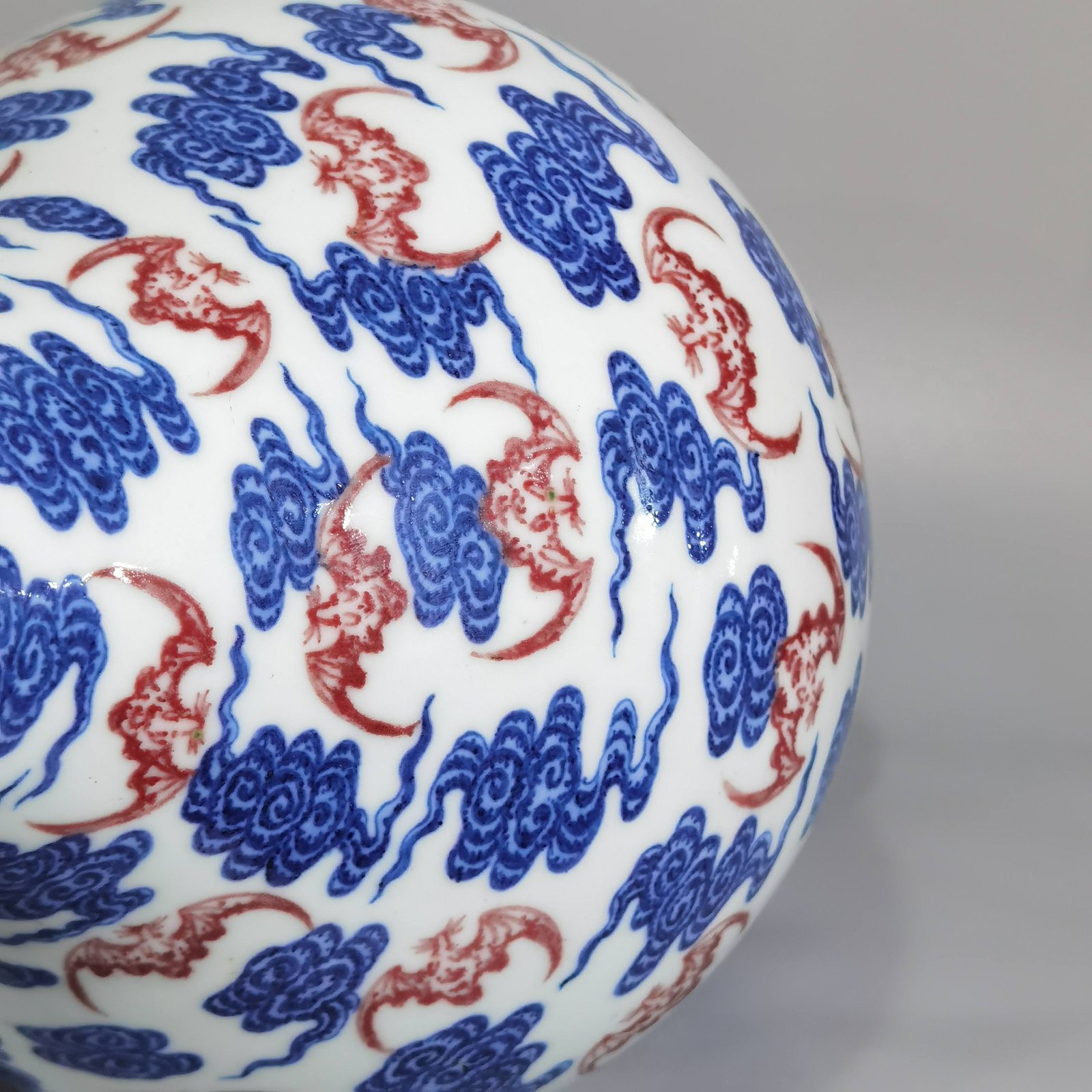 Qing Dynasty Qianlong blue and white underglaze red cloud bat pattern olive vase