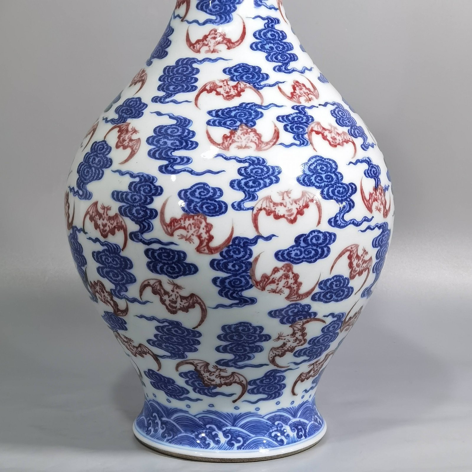 Qing Dynasty Qianlong blue and white underglaze red cloud bat pattern olive vase