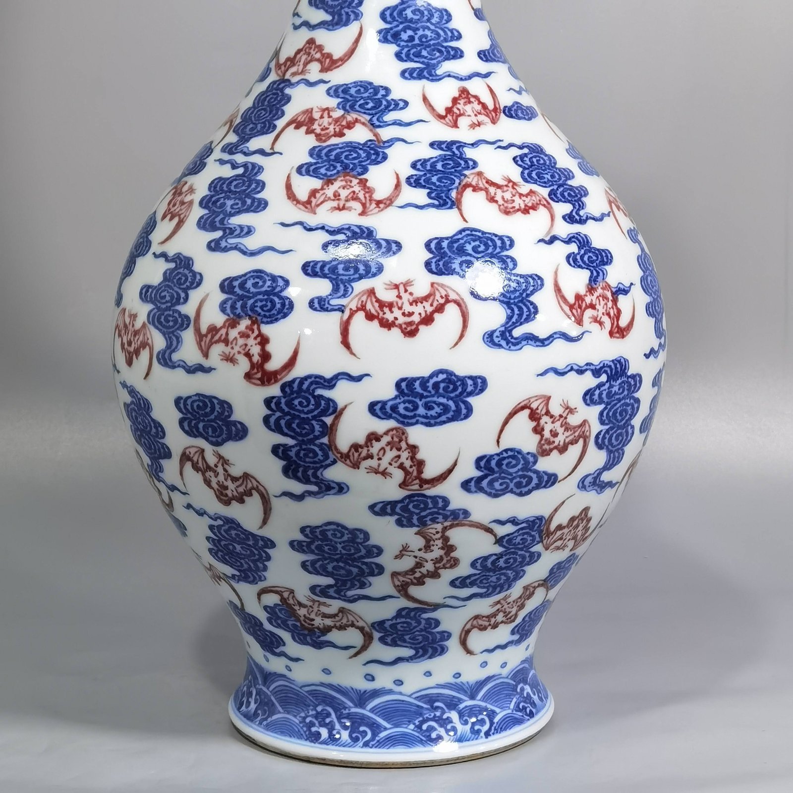 Qing Dynasty Qianlong blue and white underglaze red cloud bat pattern olive vase