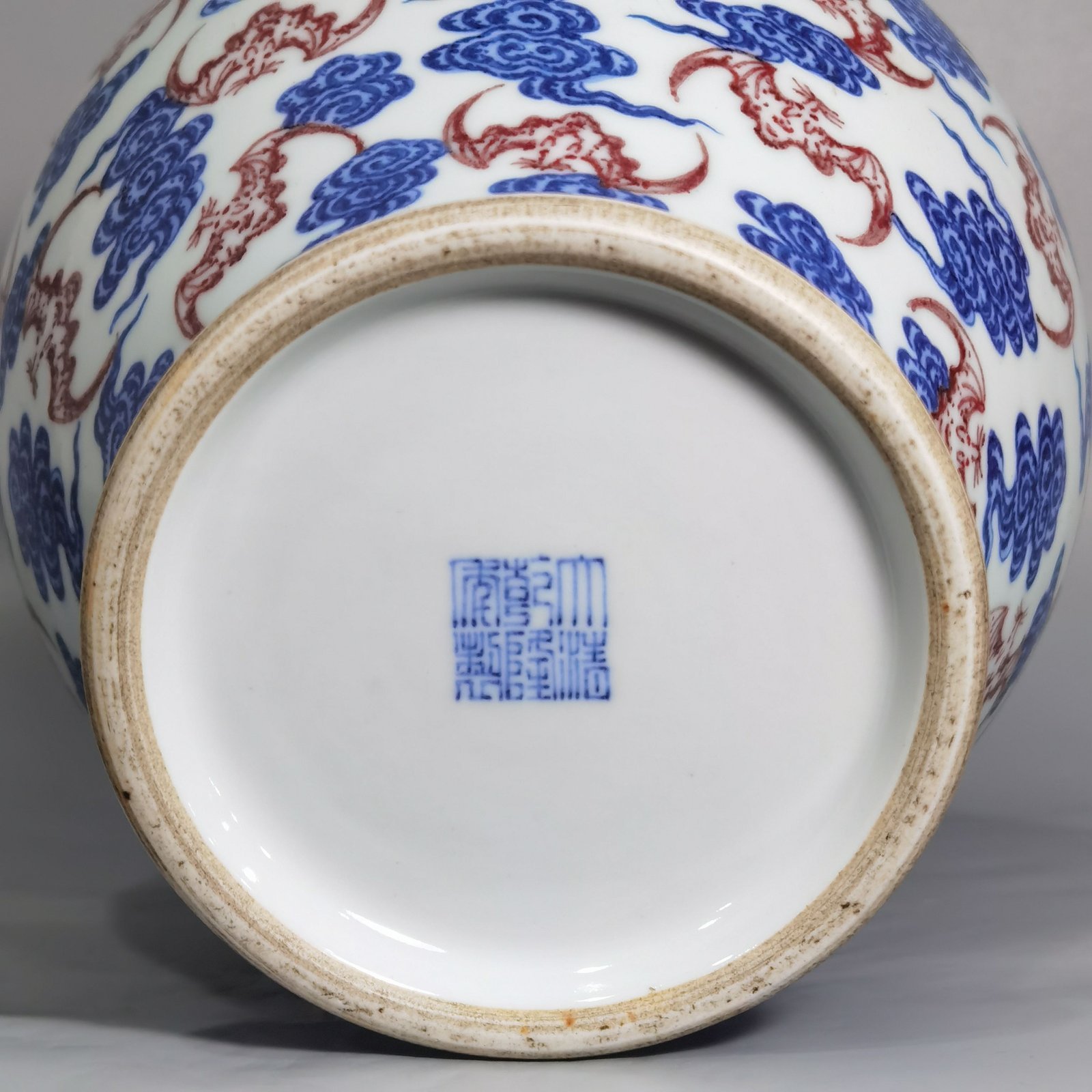 Qing Dynasty Qianlong blue and white underglaze red cloud bat pattern olive vase