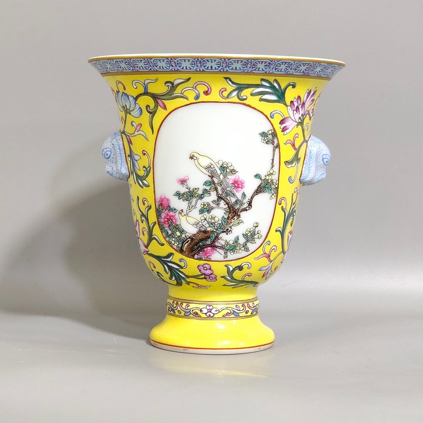 Qing Dynasty Qianlong lemon yellow window flower and bird goblet with two ears