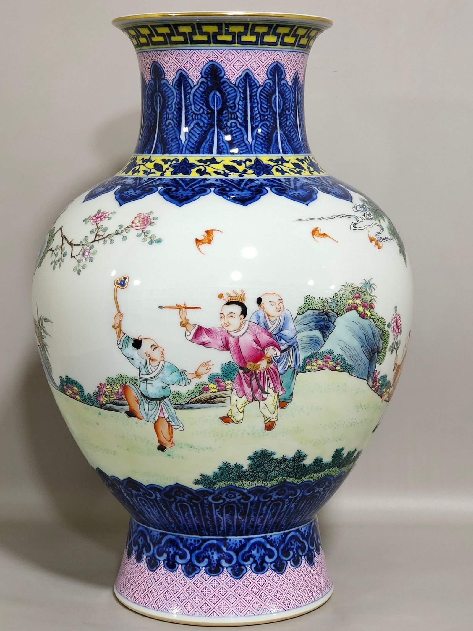 Qing Dynasty Qianlong blue and white and pastel figure boy vase
