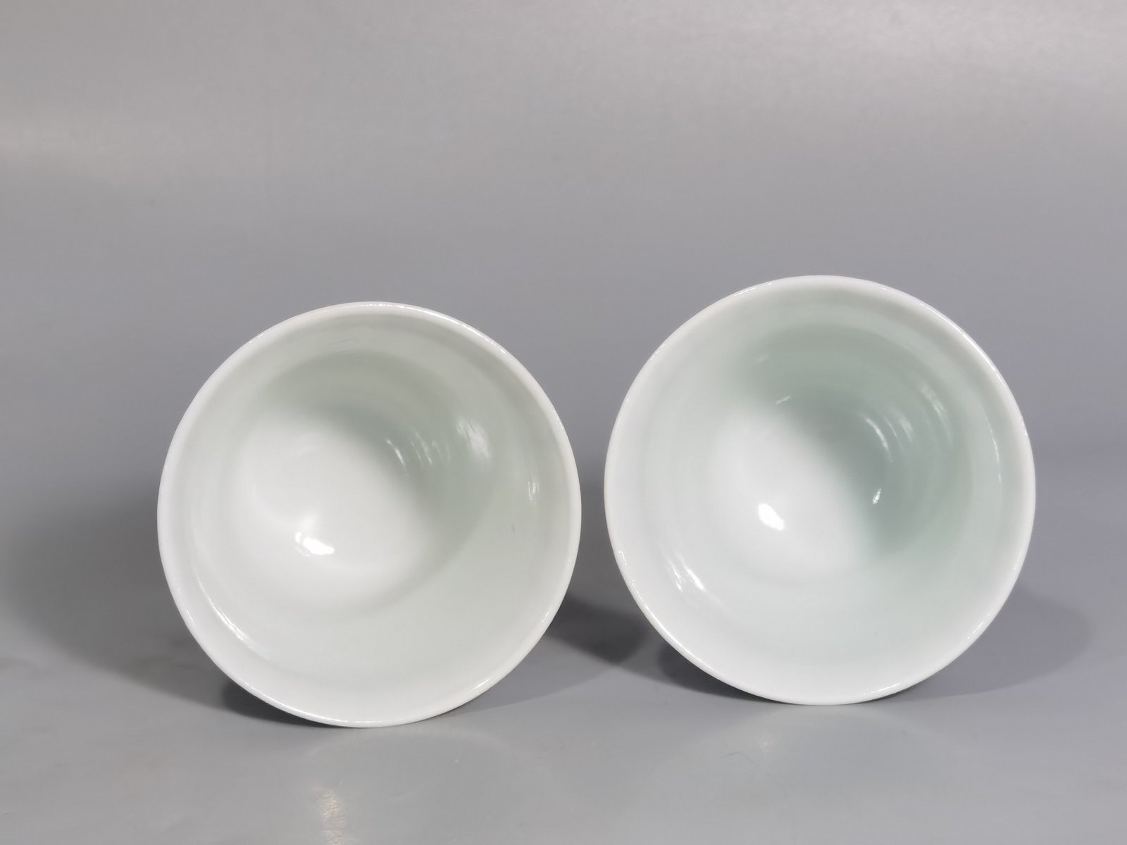 Qing Dynasty Kangxi blue and white colorful spring night banquet peach and plum garden poetry bell cup