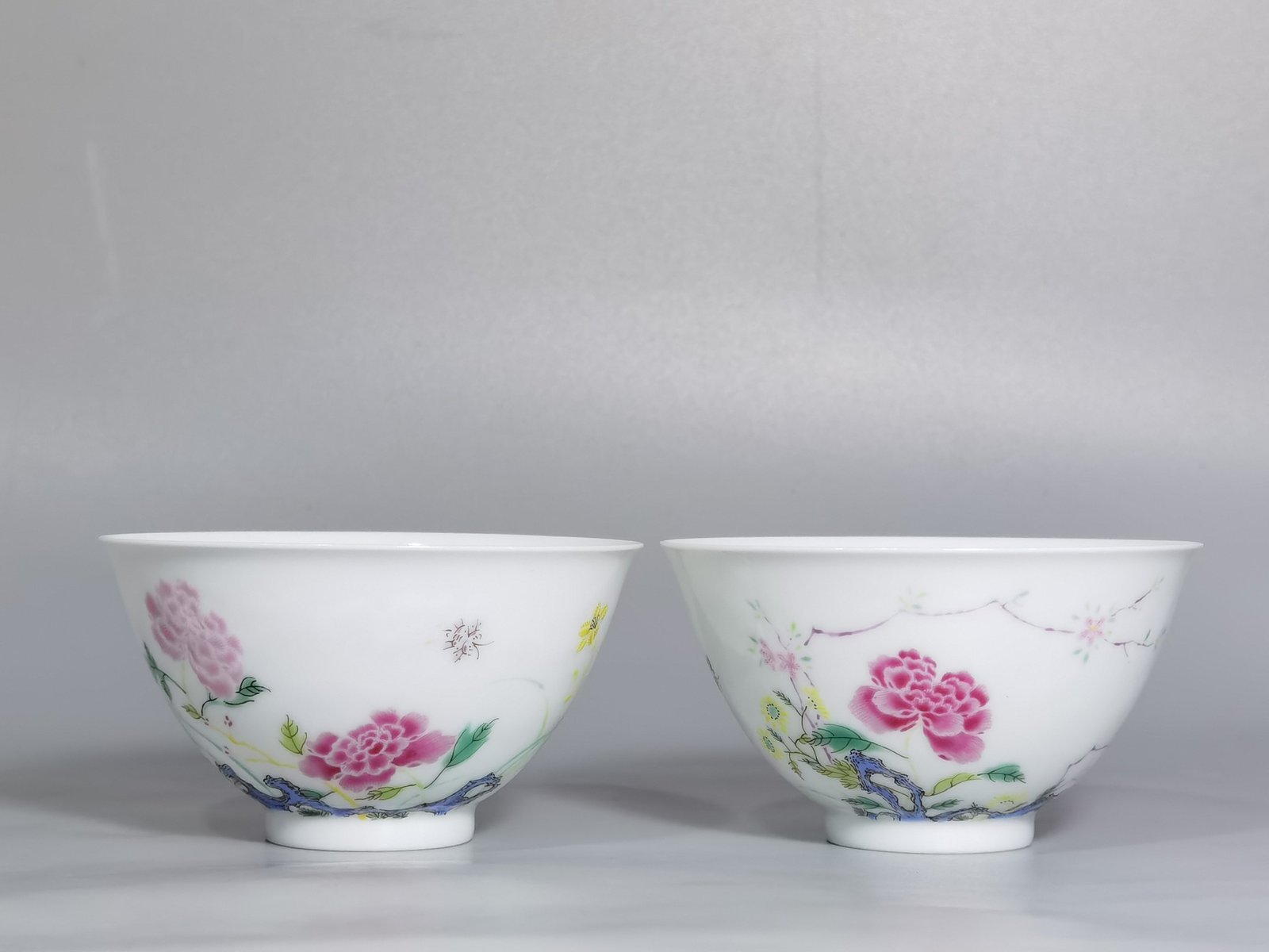 Qing Dynasty Yongzheng pair of tea circles with pastel peonies and poems