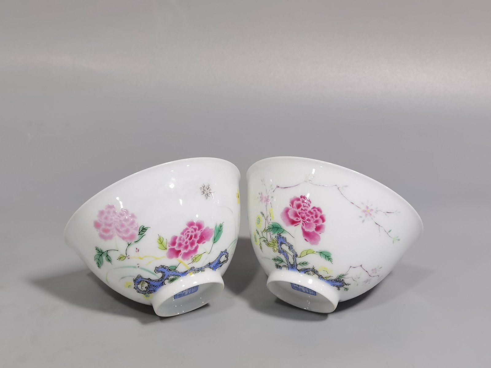 Qing Dynasty Yongzheng pair of tea circles with pastel peonies and poems