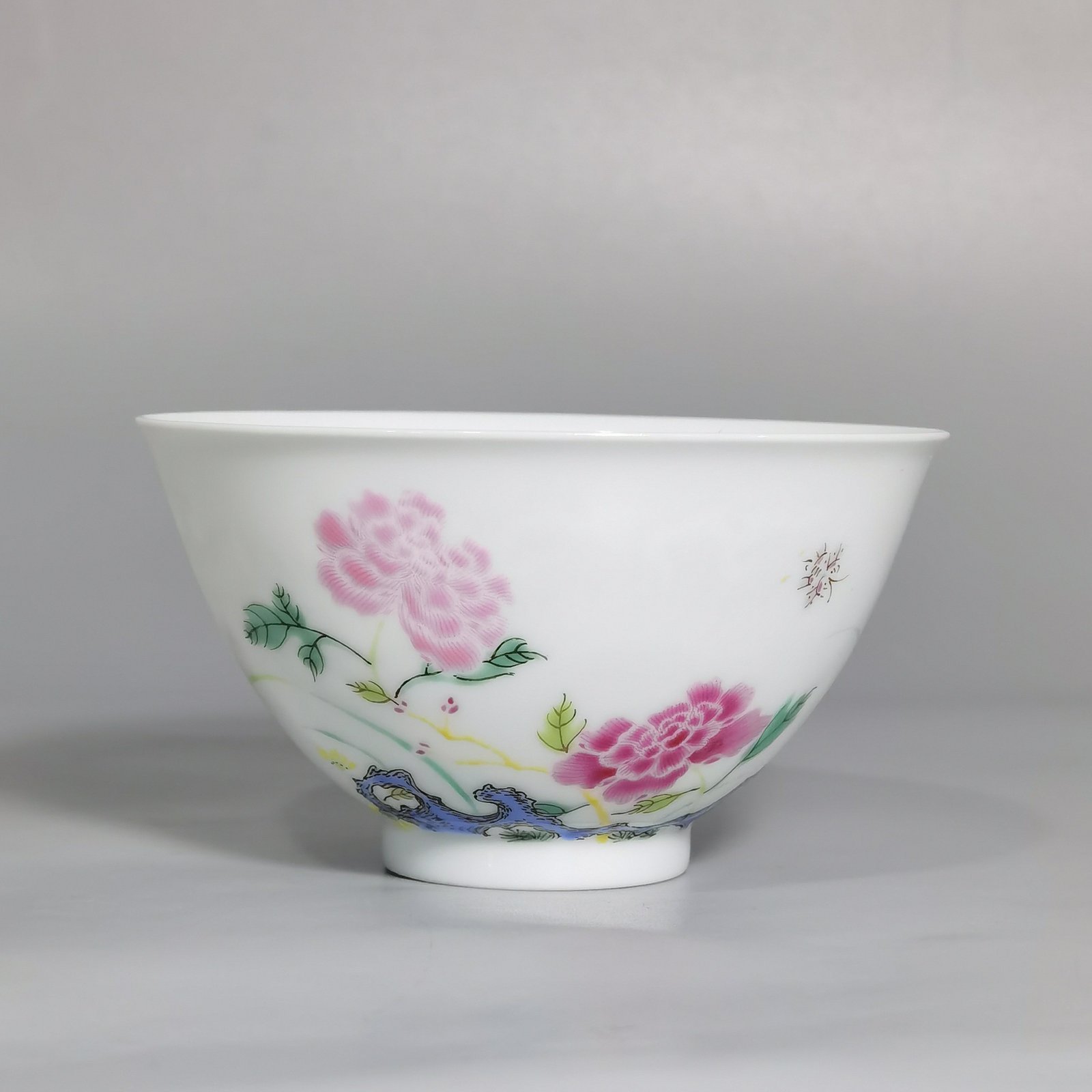 Qing Dynasty Yongzheng pair of tea circles with pastel peonies and poems