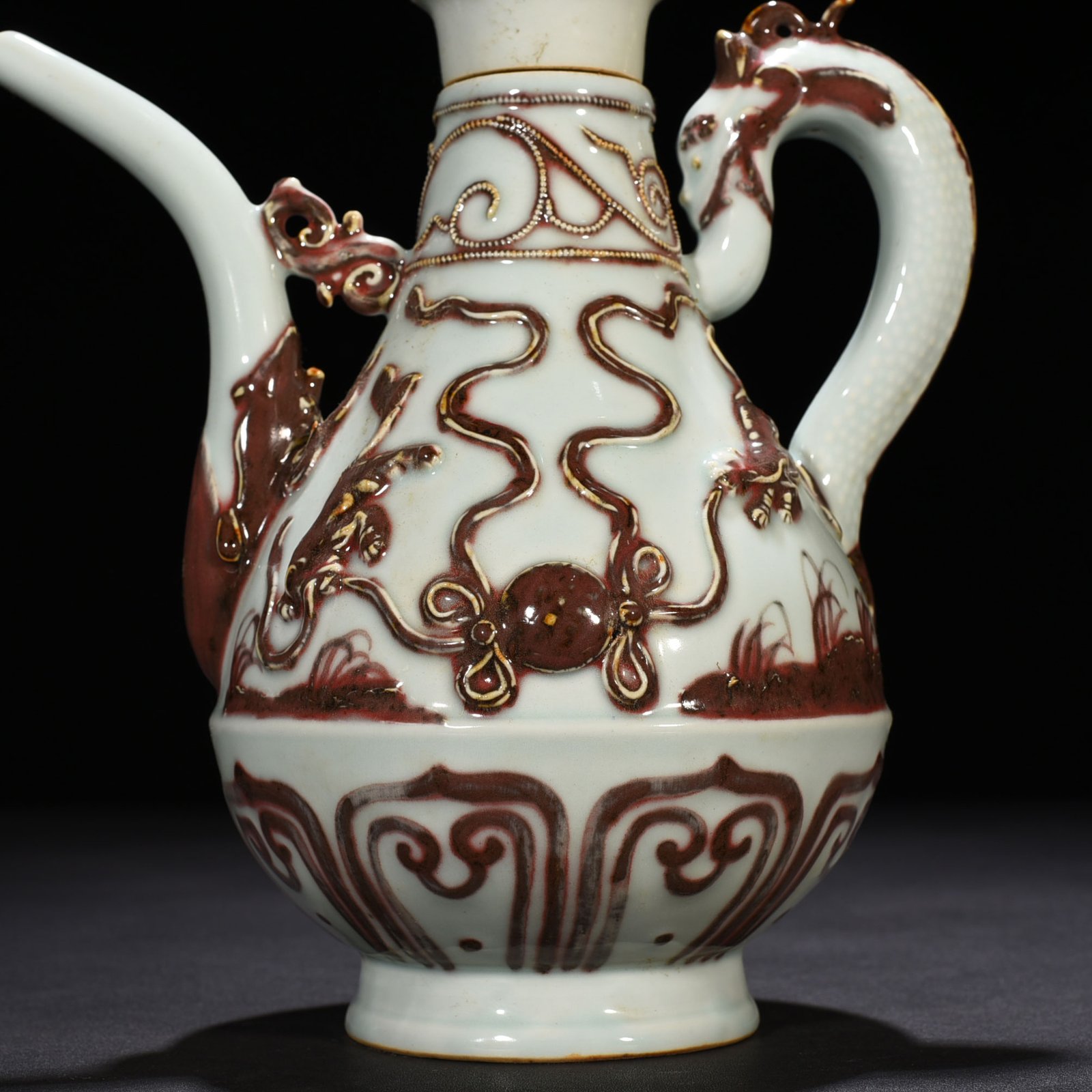 Yuan Dynasty underglaze red embossed lion rolling hydrangea and holding a pot