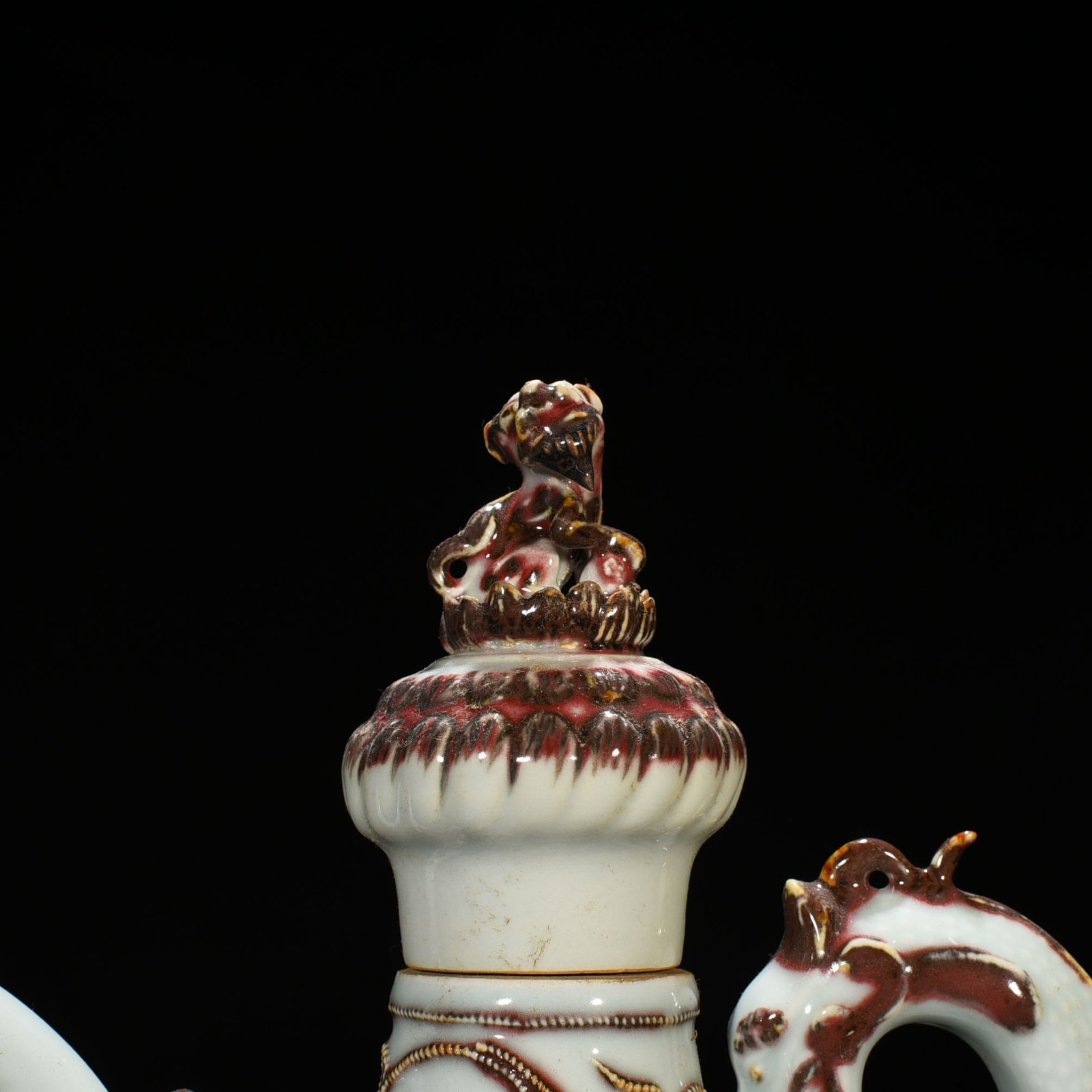 Yuan Dynasty underglaze red embossed lion rolling hydrangea and holding a pot