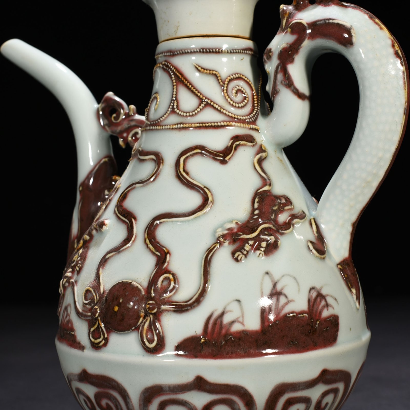 Yuan Dynasty underglaze red embossed lion rolling hydrangea and holding a pot