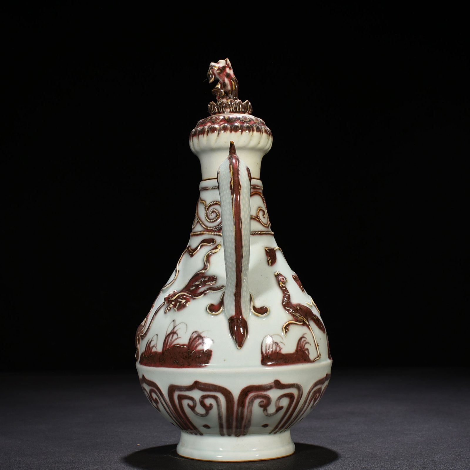 Yuan Dynasty underglaze red embossed lion rolling hydrangea and holding a pot
