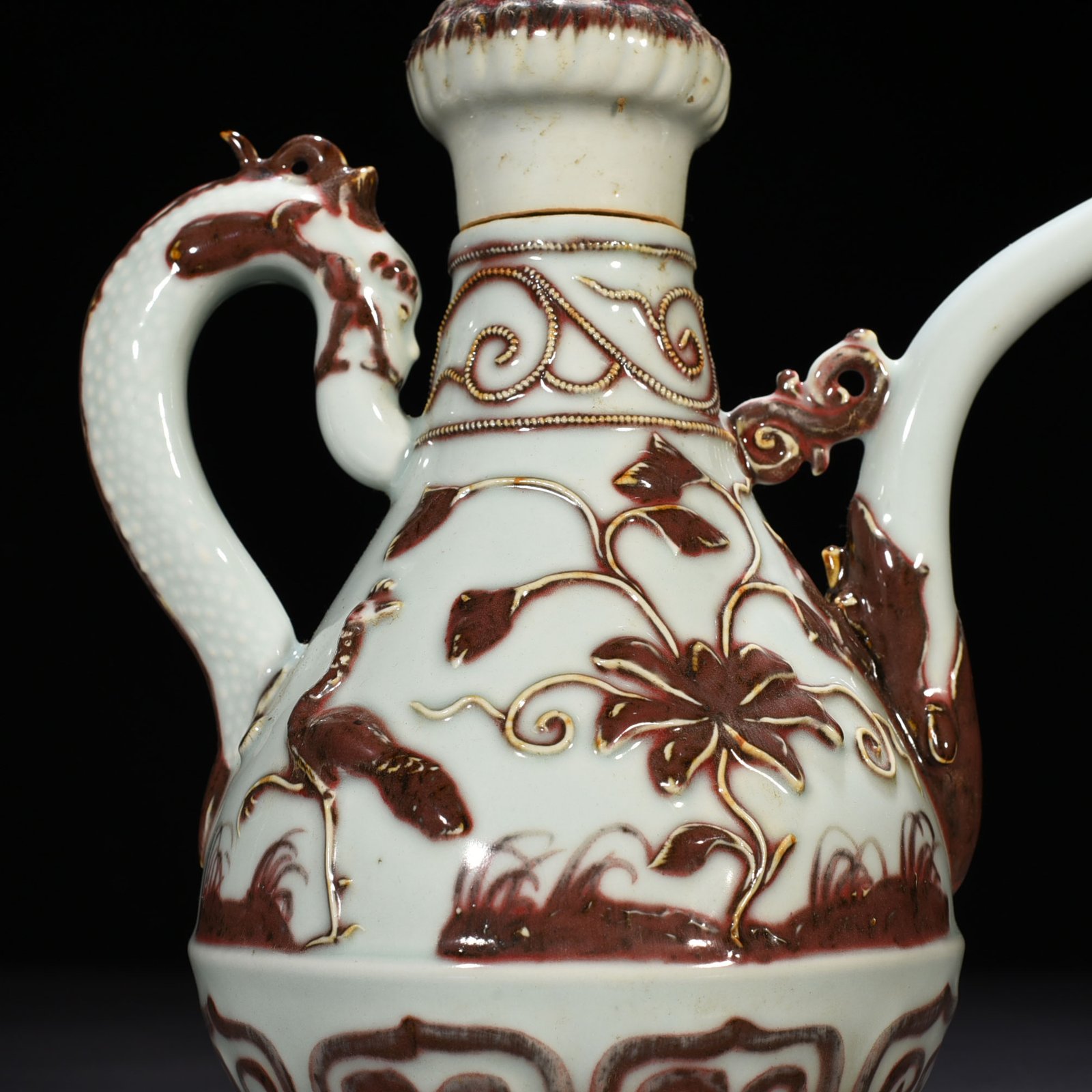 Yuan Dynasty underglaze red embossed lion rolling hydrangea and holding a pot