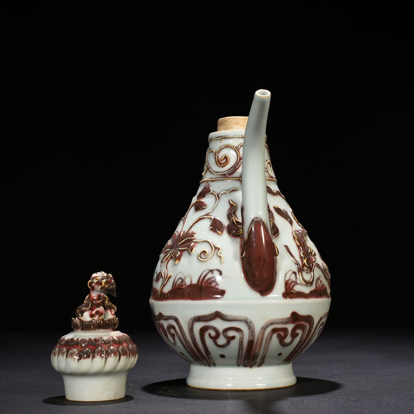 Yuan Dynasty underglaze red embossed lion rolling hydrangea and holding a pot