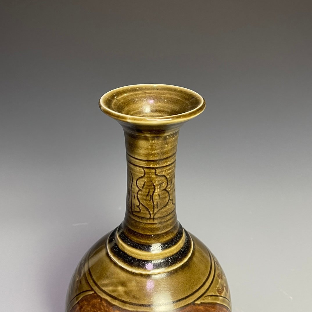 Song Dynasty Ding kiln carved figure-shaped long-neck bottle