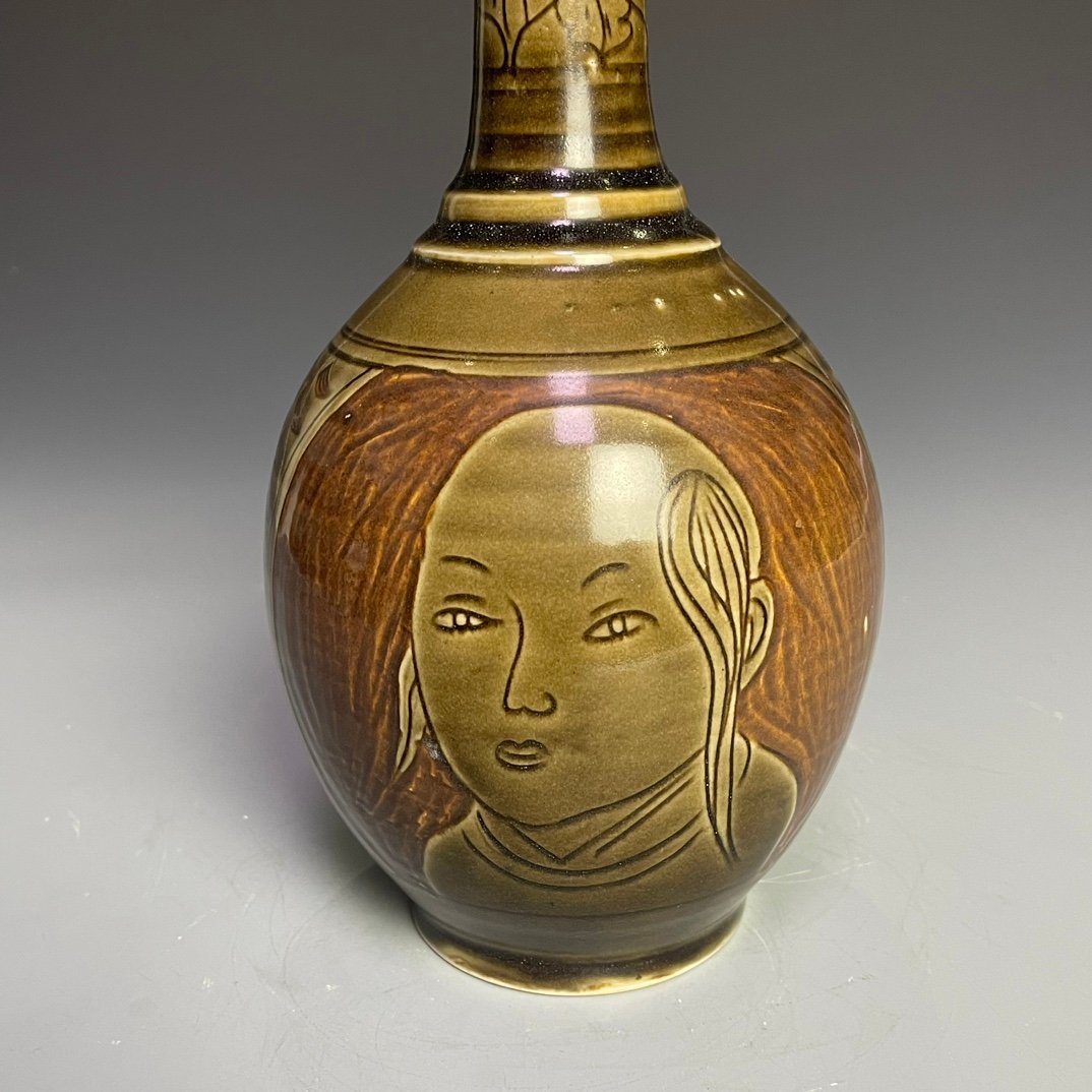 Song Dynasty Ding kiln carved figure-shaped long-neck bottle