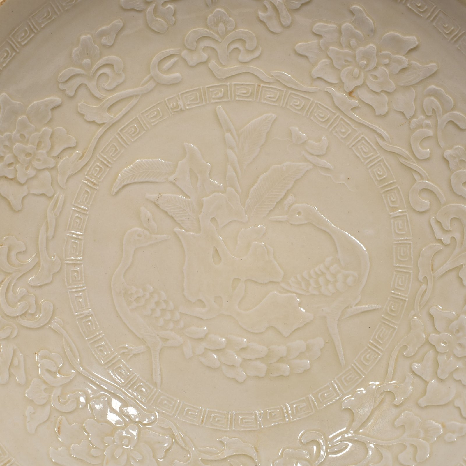 Song Dynasty Ding kiln carved peacock and peony pattern plate