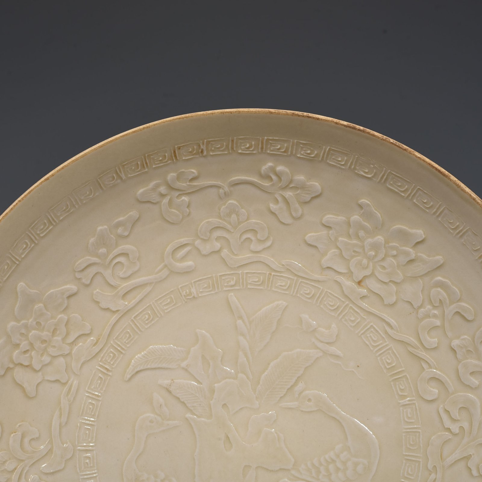 Song Dynasty Ding kiln carved peacock and peony pattern plate