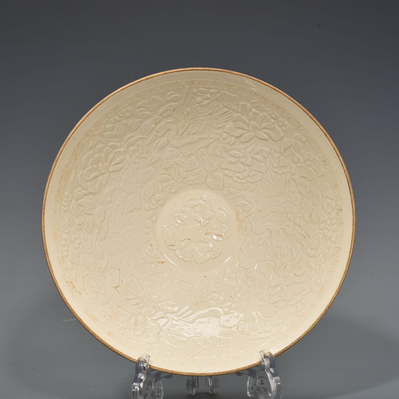 Song Dynasty Ding Kiln carved flower and bird pattern bowl