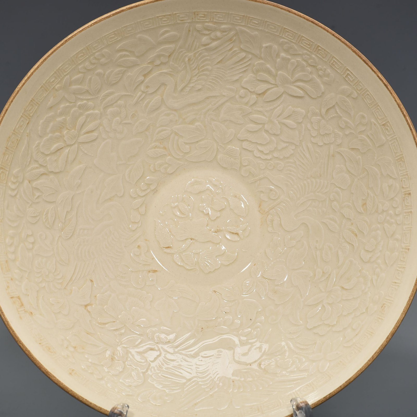 Song Dynasty Ding Kiln carved flower and bird pattern bowl