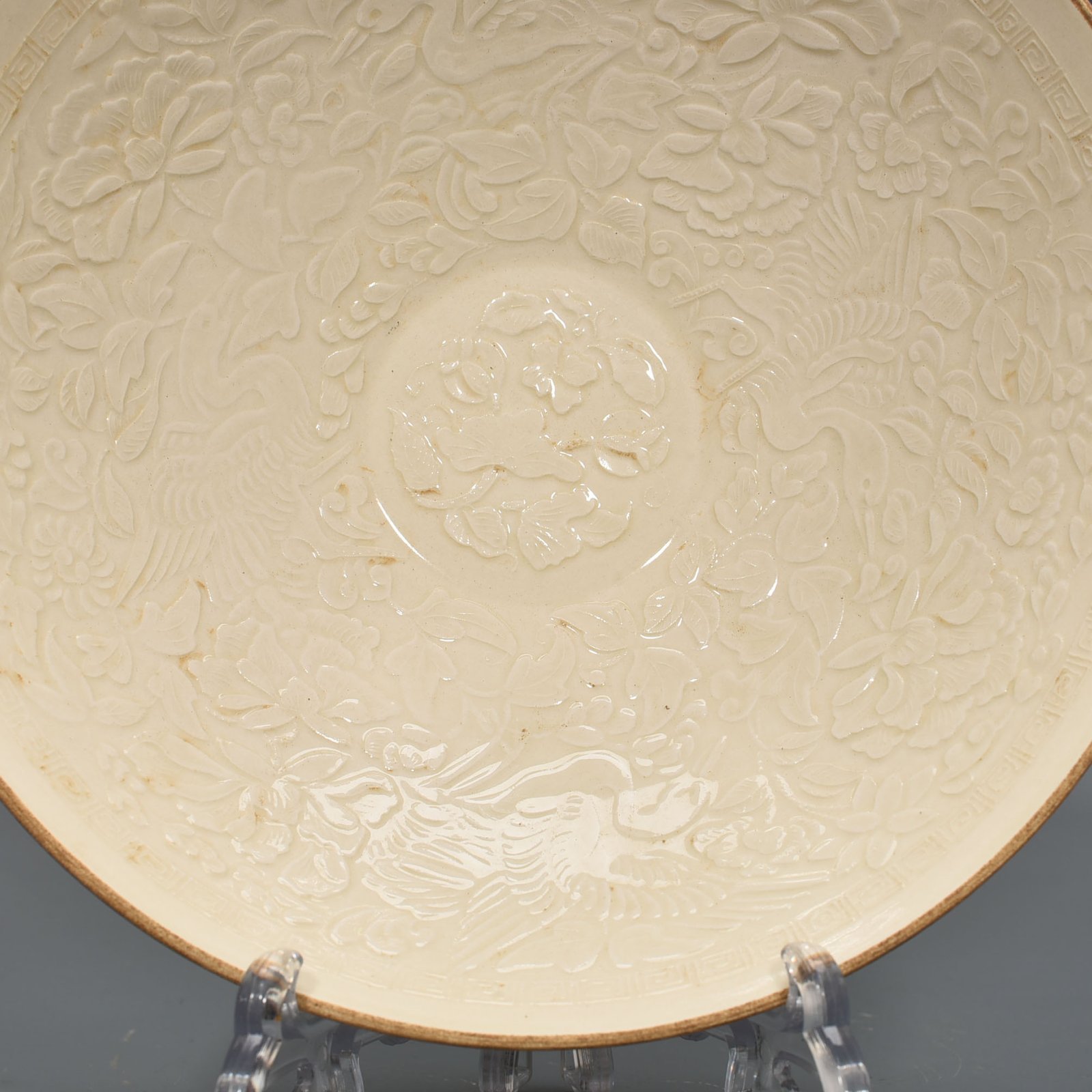 Song Dynasty Ding Kiln carved flower and bird pattern bowl