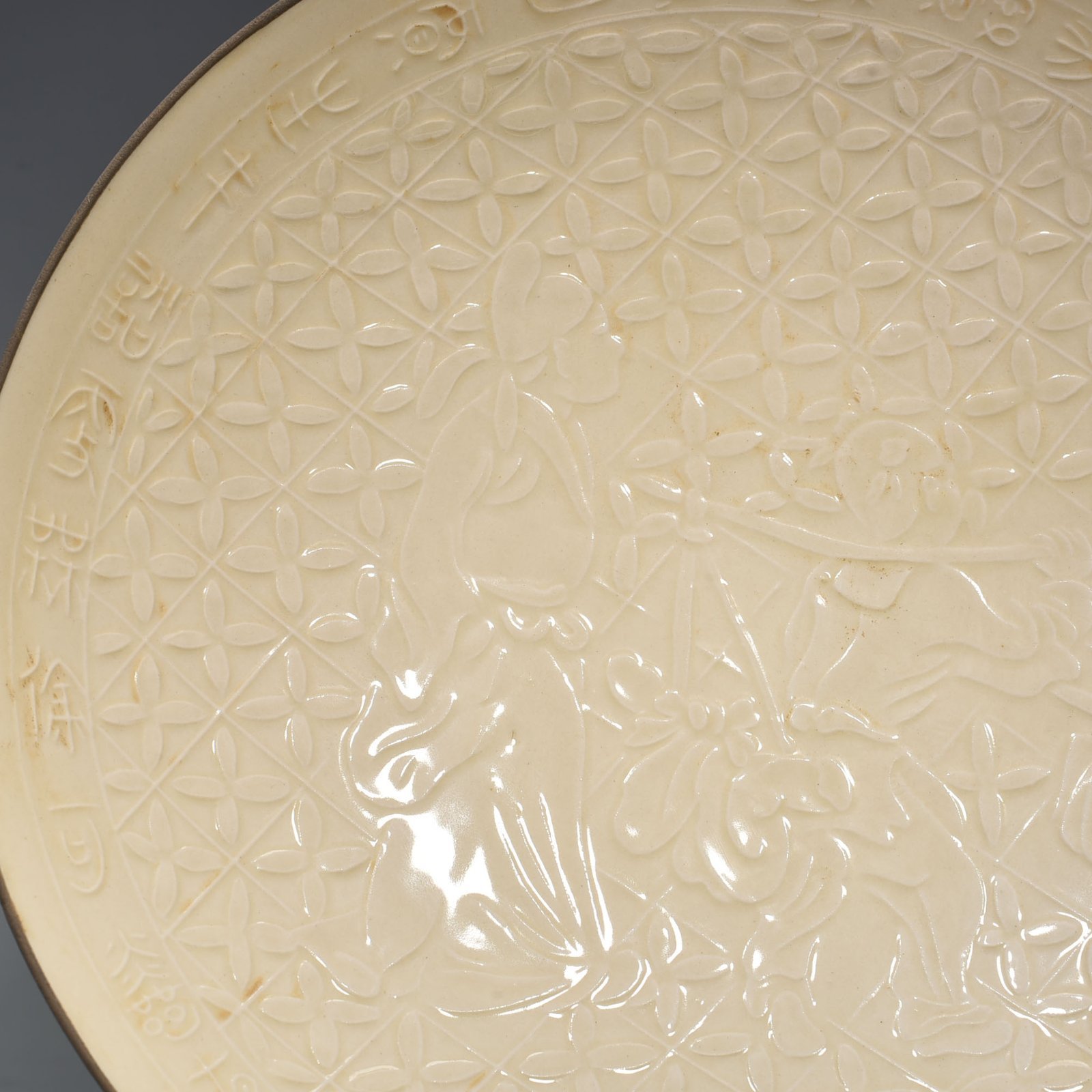 Song Dynasty Ding kiln carved plate with figures of Taoist figures