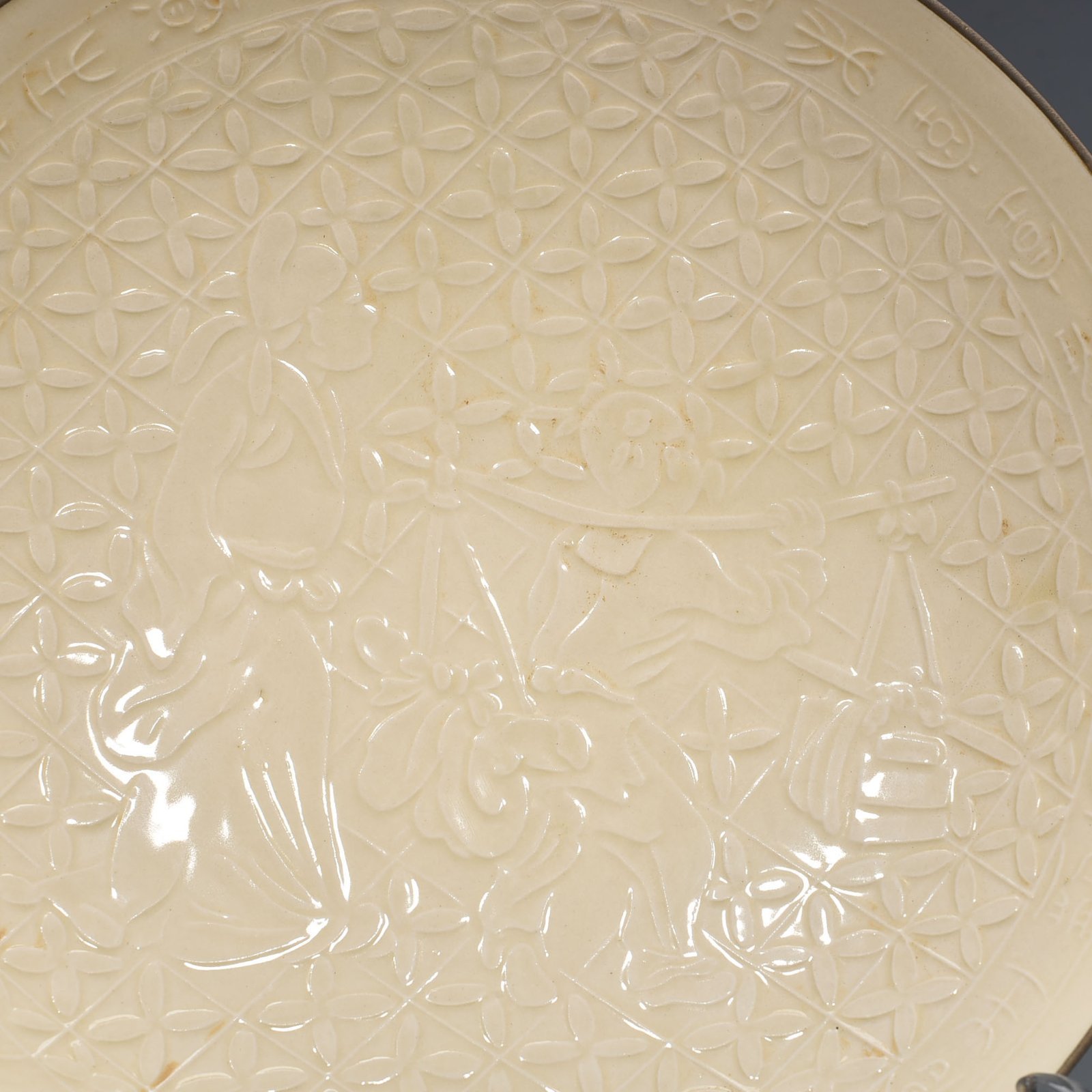 Song Dynasty Ding kiln carved plate with figures of Taoist figures