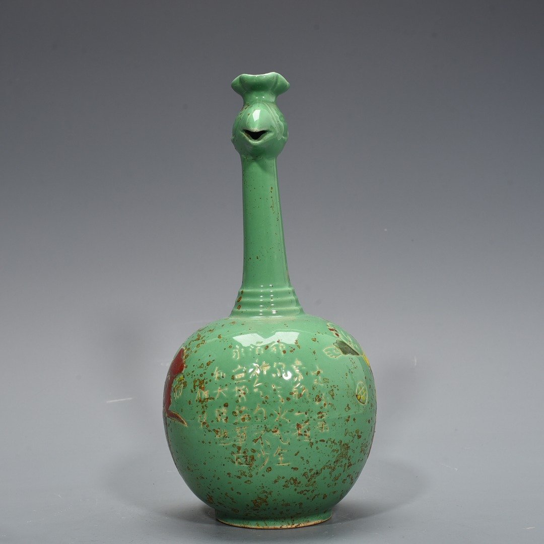 Song Dynasty Ding kiln style green glaze engraved with baby playing pattern and phoenix head pot