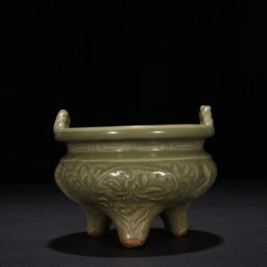 Song Dynasty Longquan kiln plum green glaze carved with branches and flowers pattern three-legged stove