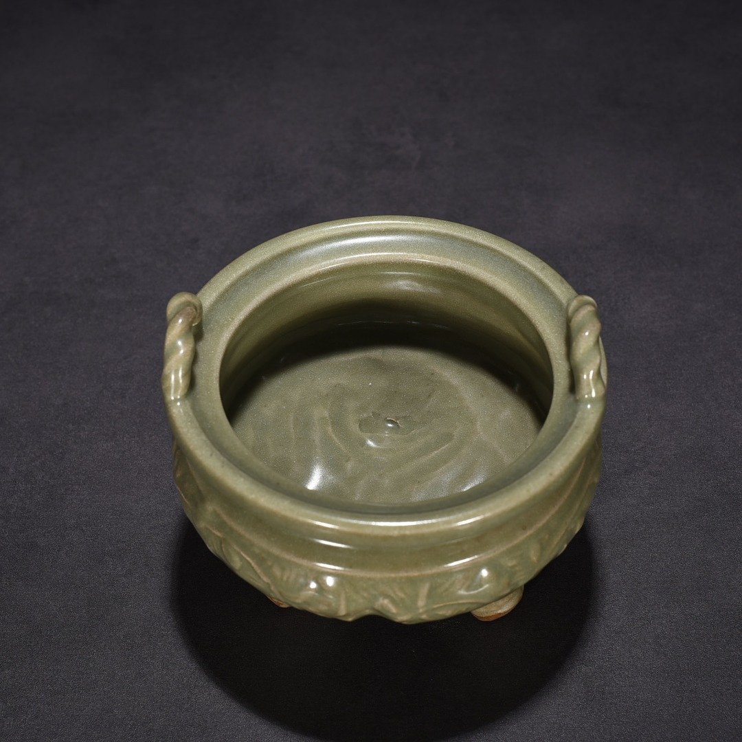 Song Dynasty Longquan kiln plum green glaze carved with branches and flowers pattern three-legged stove