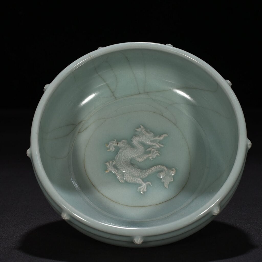 Song Dynasty Longquan kiln pink celadon glaze stacked dragon pattern drum nail wash
